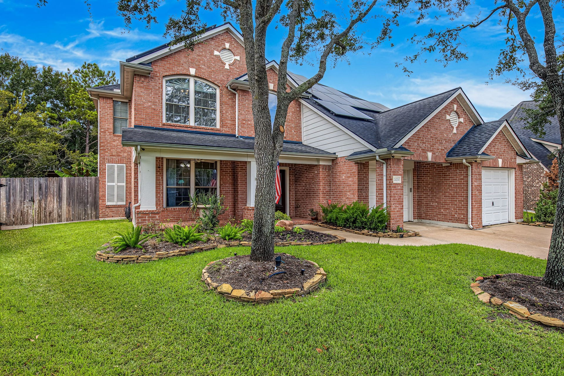 21223 Dover Park Lane, Katy, TX 77450 Charming two-story brick home with lush landscaping and a welcoming covered porch.