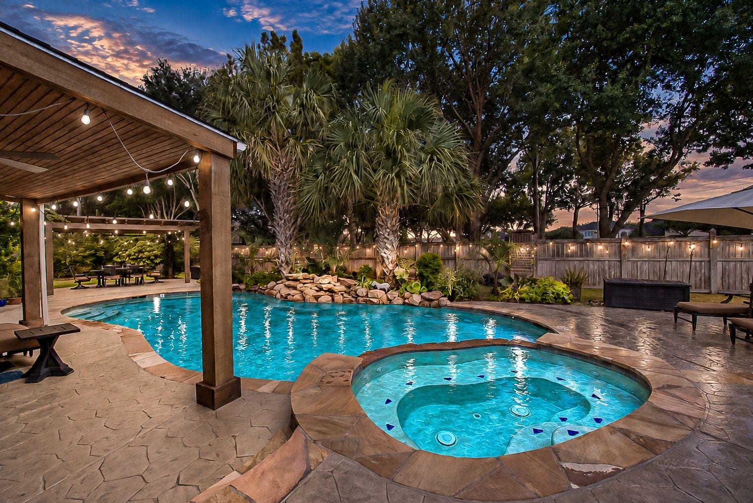 21223 Dover Park Lane, Katy, TX 77450 Experience luxury outdoor living with a stunning pool and spa, surrounded by lush landscaping and a spacious patio, perfect for relaxation and entertaining under the stars.