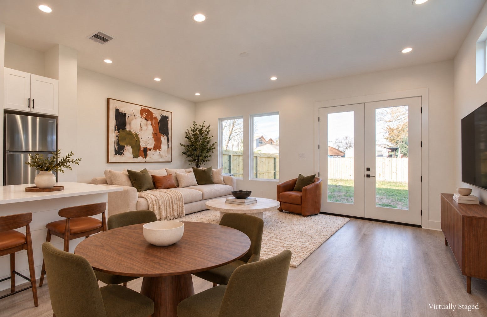 4425 Providence Street, Houston, TX 77020 Windows and French doors bring natural light into the living area and connect it directly to the backyard, making an afternoon at home feel a little more open and inviting. Virtually staged.