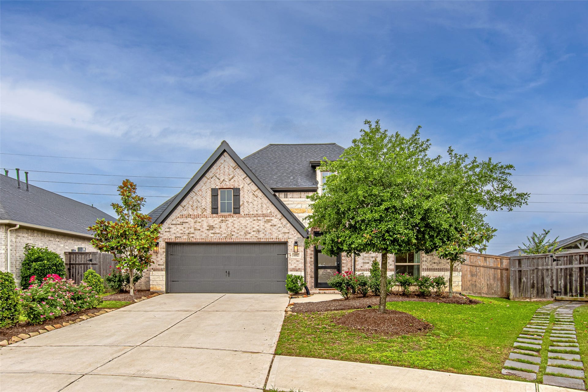 Beautifully maintained home with inviting curb appeal, spacious driveway, and modern exterior finishes.