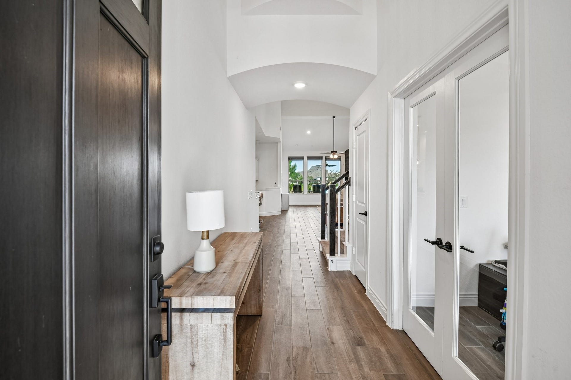 24110 Hawthorn Breeze Way, Katy, TX 77493 Extended entry hall with wood-look vinyl plank flooring and a direct sightline into the main living areas
