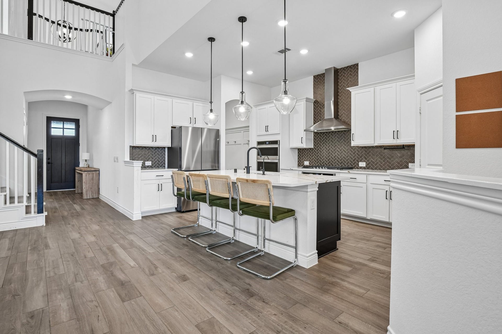 24110 Hawthorn Breeze Way, Katy, TX 77493 Second kitchen angle showing white cabinetry, extended counters, and clear flow into the dining area