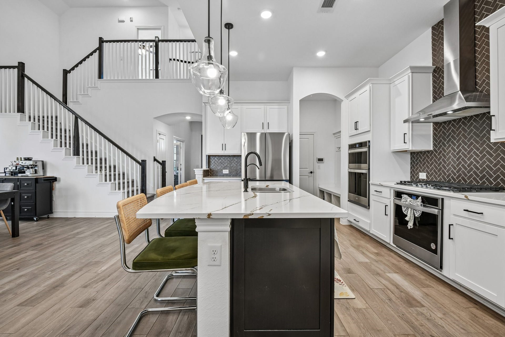 24110 Hawthorn Breeze Way, Katy, TX 77493 Open-concept main level connects the kitchen, dining space, family room, and staircase