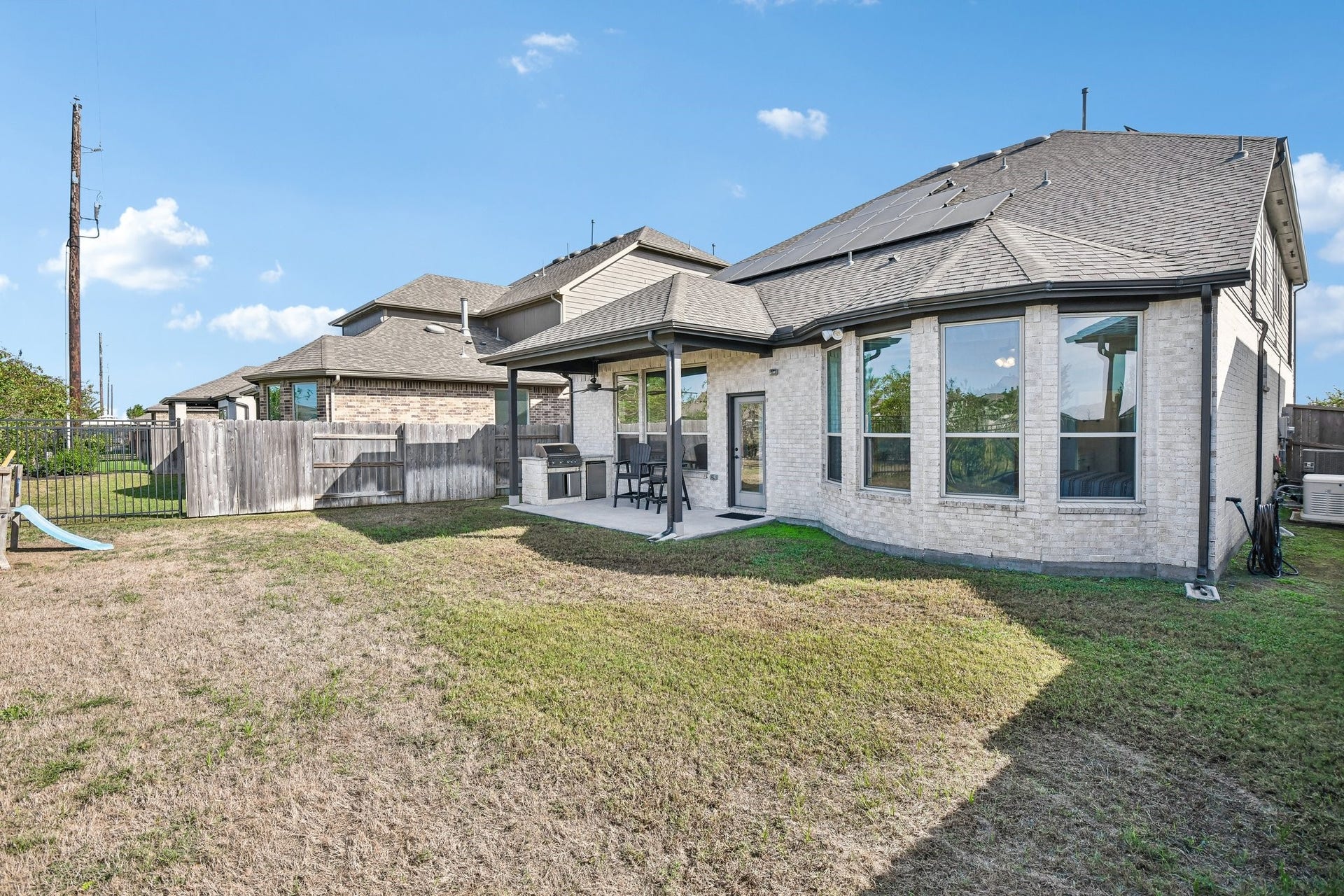 24110 Hawthorn Breeze Way, Katy, TX 77493 Rear elevation with covered patio, large windows, and direct access to the backyard