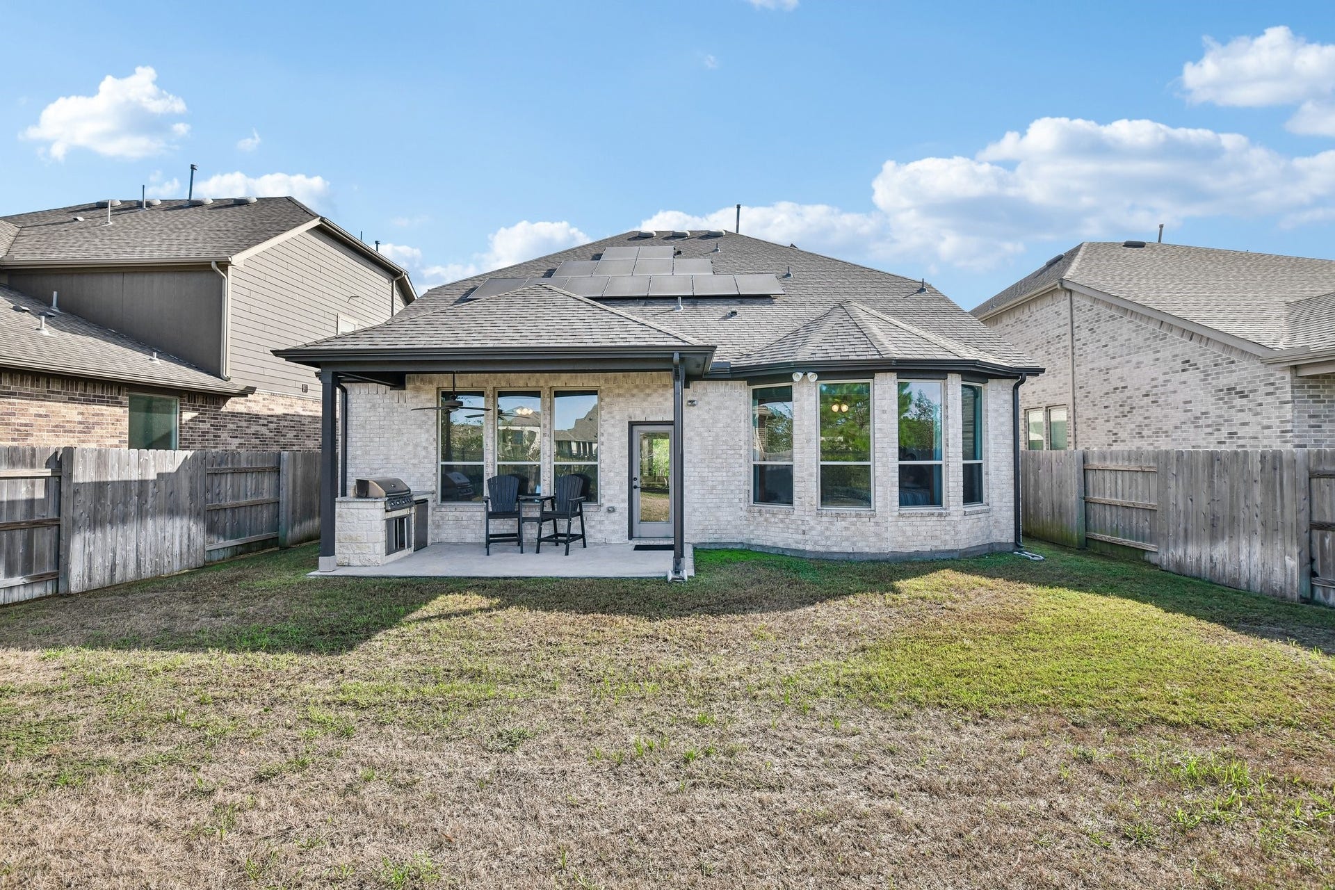 24110 Hawthorn Breeze Way, Katy, TX 77493 Full rear exterior showing the home centered across the width of the lot