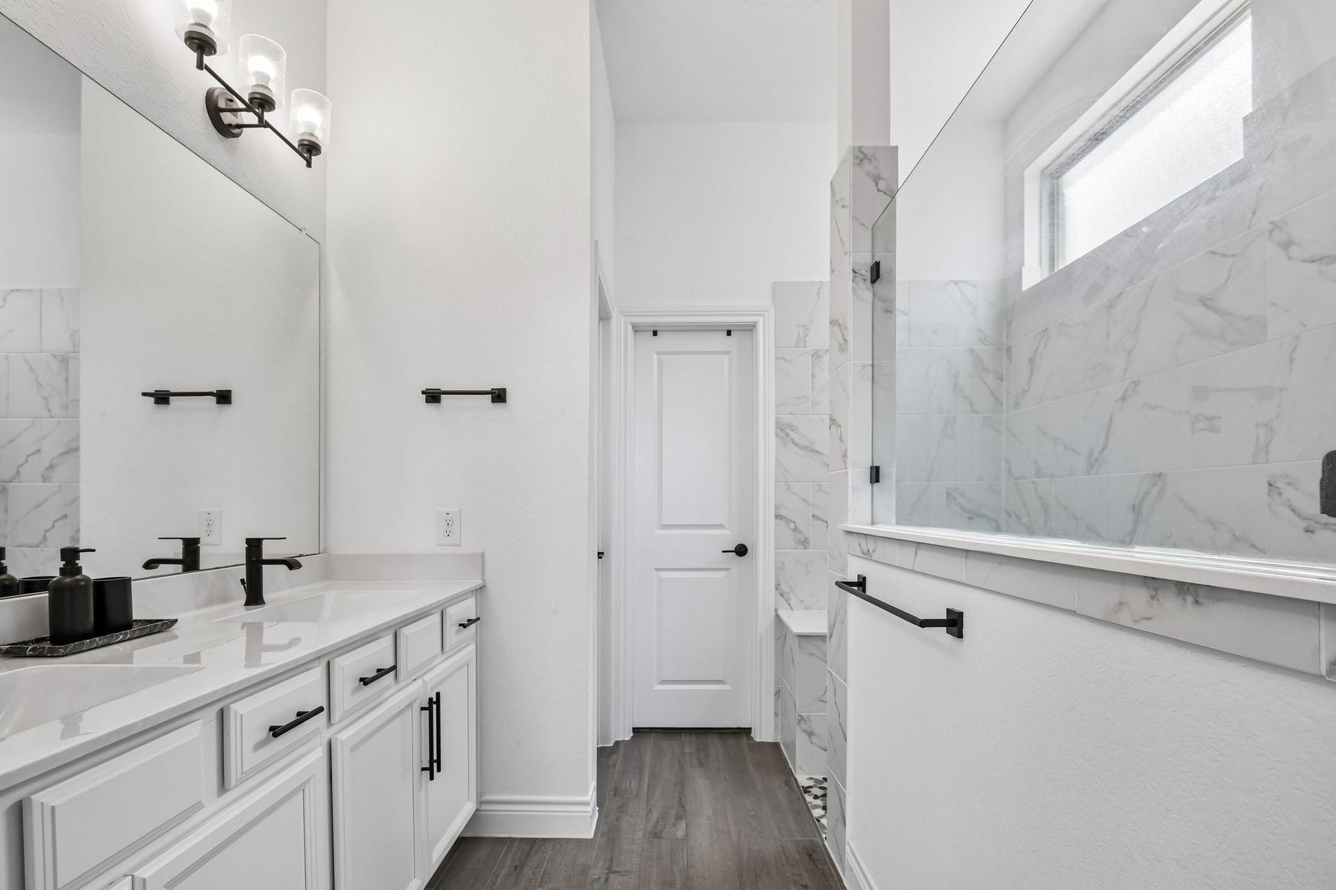 24110 Hawthorn Breeze Way, Katy, TX 77493 Marble-look primary bath with dual sinks, oversized glass walk-in shower, and walk-in closet