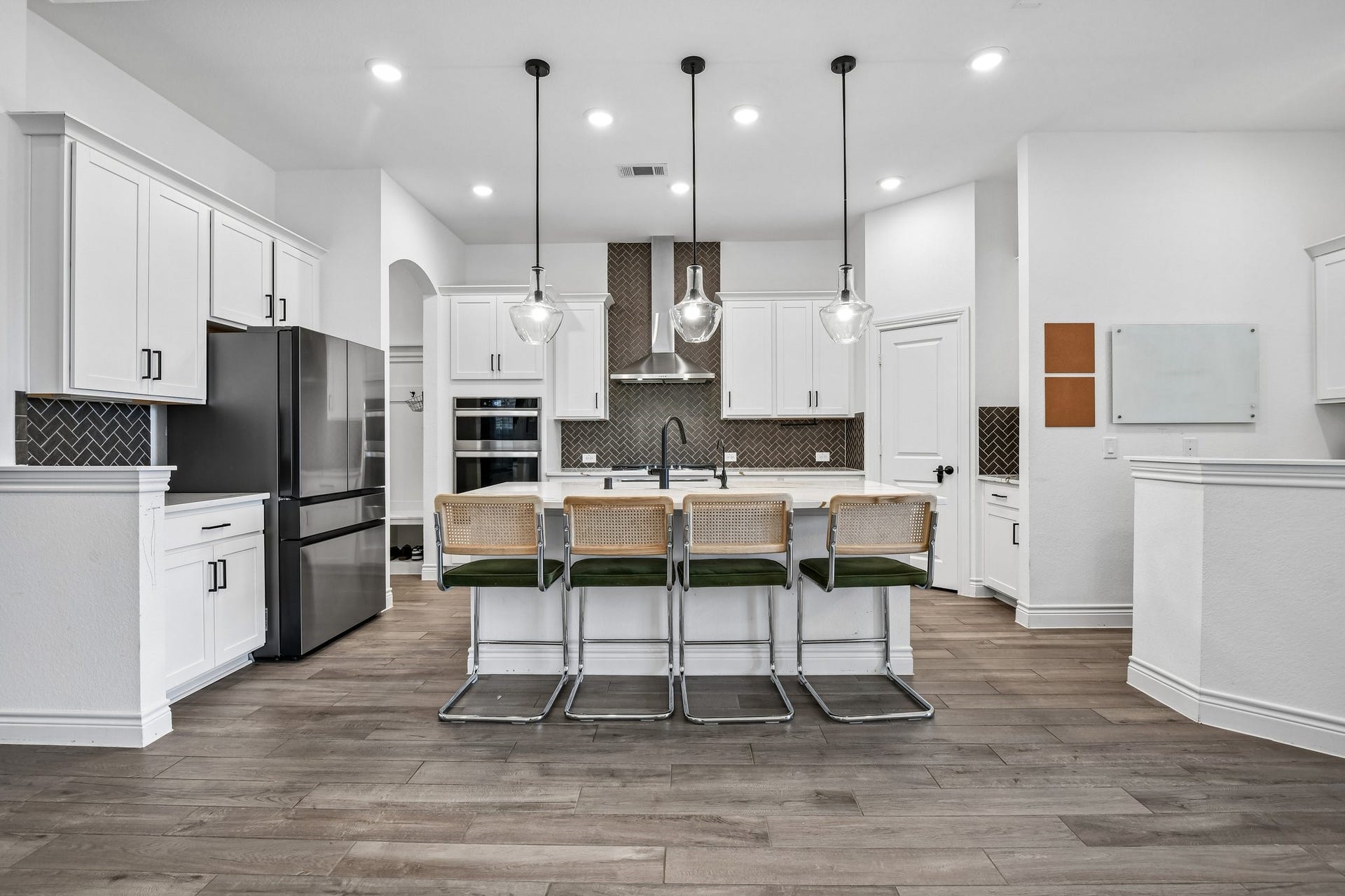 24110 Hawthorn Breeze Way, Katy, TX 77493 Oversized quartz island anchors the kitchen with generous seating, pendant lighting, and prep space