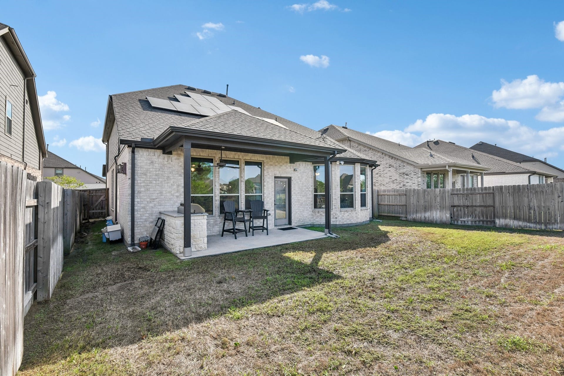 24110 Hawthorn Breeze Way, Katy, TX 77493 Rear three-quarter view showing the patio, fenced yard, and side access