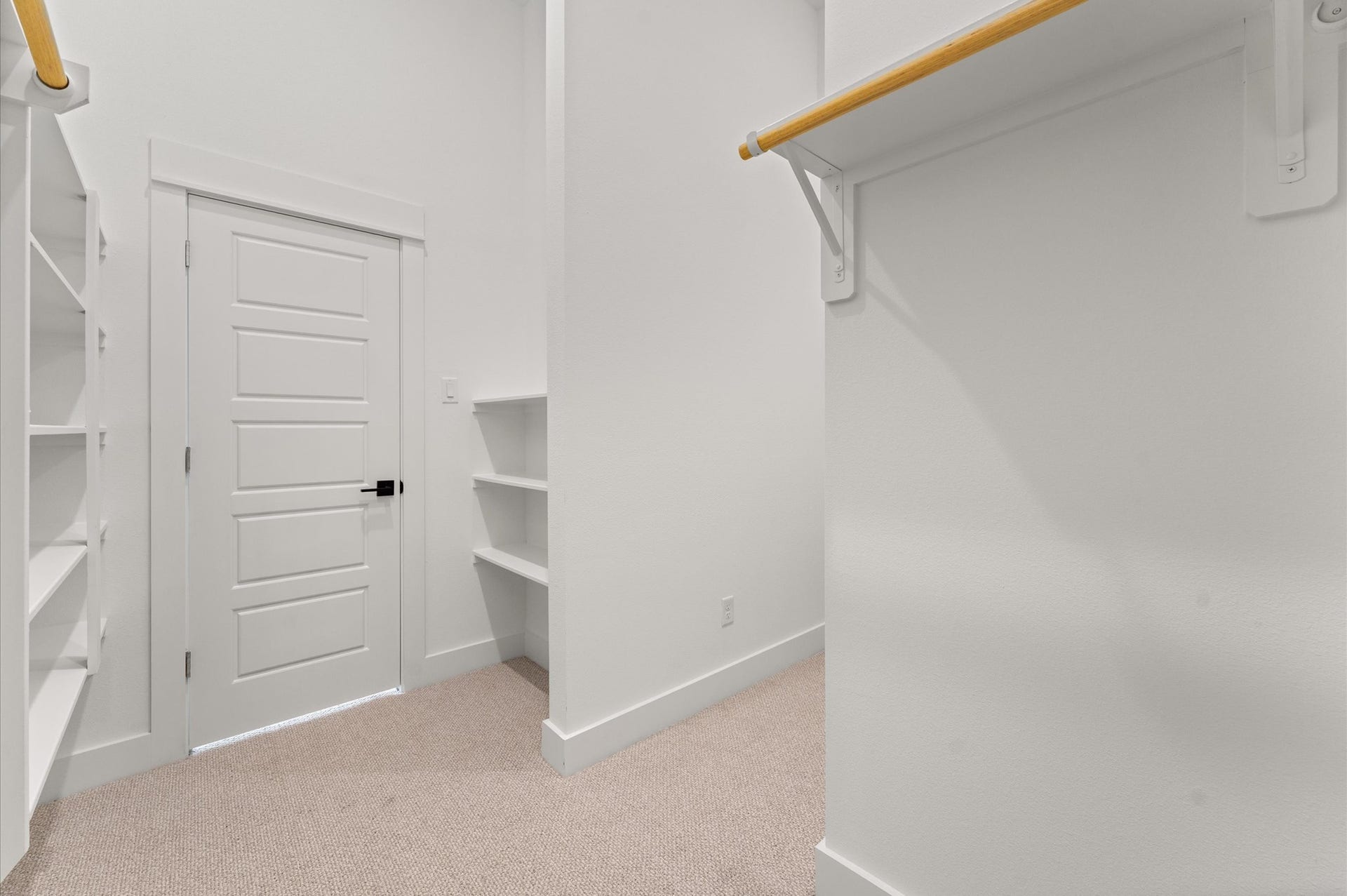 1009 Tuskegee Heights Lane, Houston, TX 77091 This expansive walk-in closet is a standout feature of the primary bedroom, offering generous space for wardrobe organization and personal storage. Thoughtfully designed shelving and hanging rods, the closet provides a boutique-like experience with room for everything from seasonal clothing to accessories.