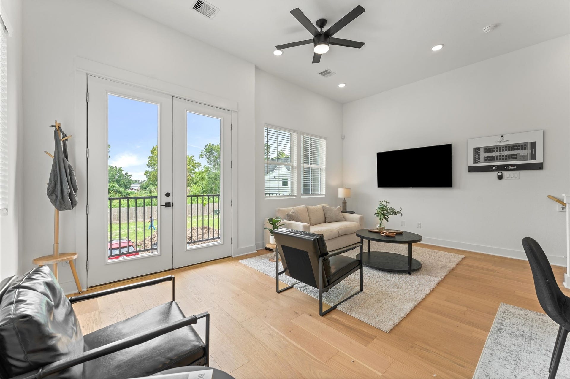 1009 Tuskegee Heights Lane, Houston, TX 77091 Airy and inviting open-concept living space located on the second floor, thoughtfully designed to enhance both comfort and flow. The area features high ceilings, expansive windows, and cohesive flooring that unify the living, dining, and kitchen zones. Elegant French doors serve as a striking focal point, leading out to a private balcony that extends the living space outdoorsperfect for morning coffee or evening unwinding.
