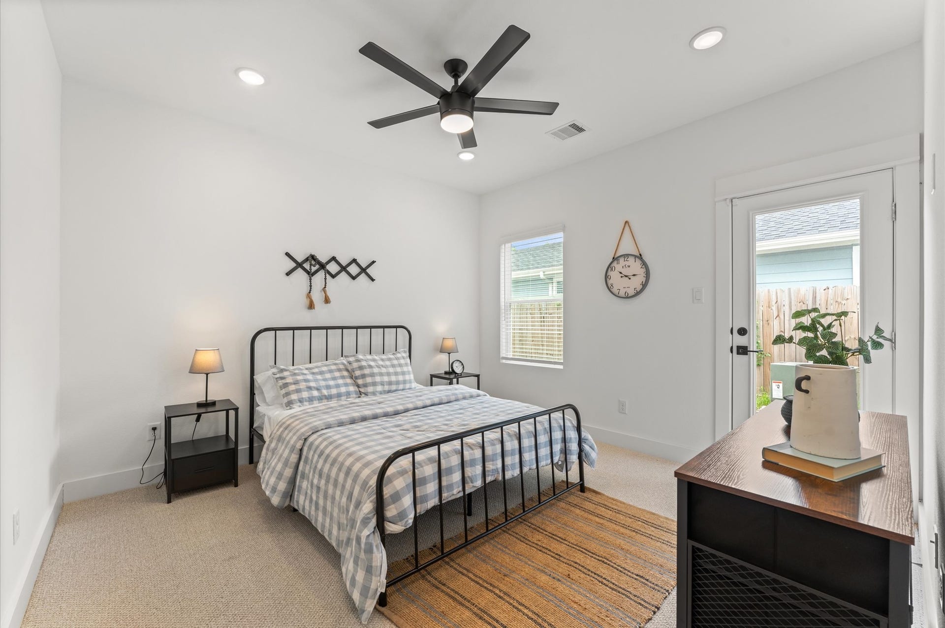 1009 Tuskegee Heights Lane, Houston, TX 77091 Stylish and versatile secondary bedroom situated on the first floor, offering direct access to the backyard through elegant glass patio door. This sunlit space features generous room for a queen-sized bed and additional furnishings - Ideal for accommodating guests or family members with ease and privacy. Outdoor access enhances the rooms appeal for relaxation, remote work, or multi-generational living.