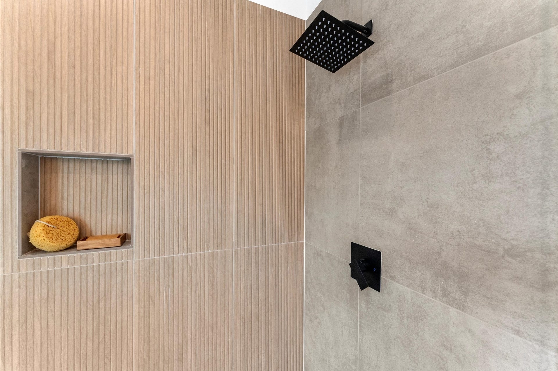 1009 Tuskegee Heights Lane, Houston, TX 77091 This luxurious primary bathroom blends modern elegance with spa-like comfort, featuring neutral tones, statement lighting, and refined tilework complete the space, creating a serene retreat thats both functional and visually stunning.