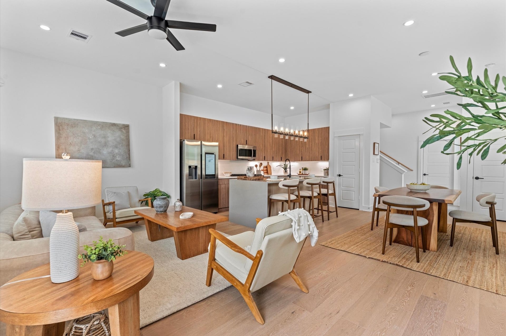 1009 Tuskegee Heights Lane, Houston, TX 77091 Expansive and light-filled open-concept layout seamlessly combining the living room, dining area, and kitchen on the second floor. The space boasts high ceilings, wide windows for abundant natural light, and elegant flooring that ties the zones together beautifully. The kitchen features modern cabinetry, sleek countertops, and a center island with bar seatingperfect for entertaining or casual meals. Adjacent dining area easily accommodates a full-size table, while the living space is inviting!