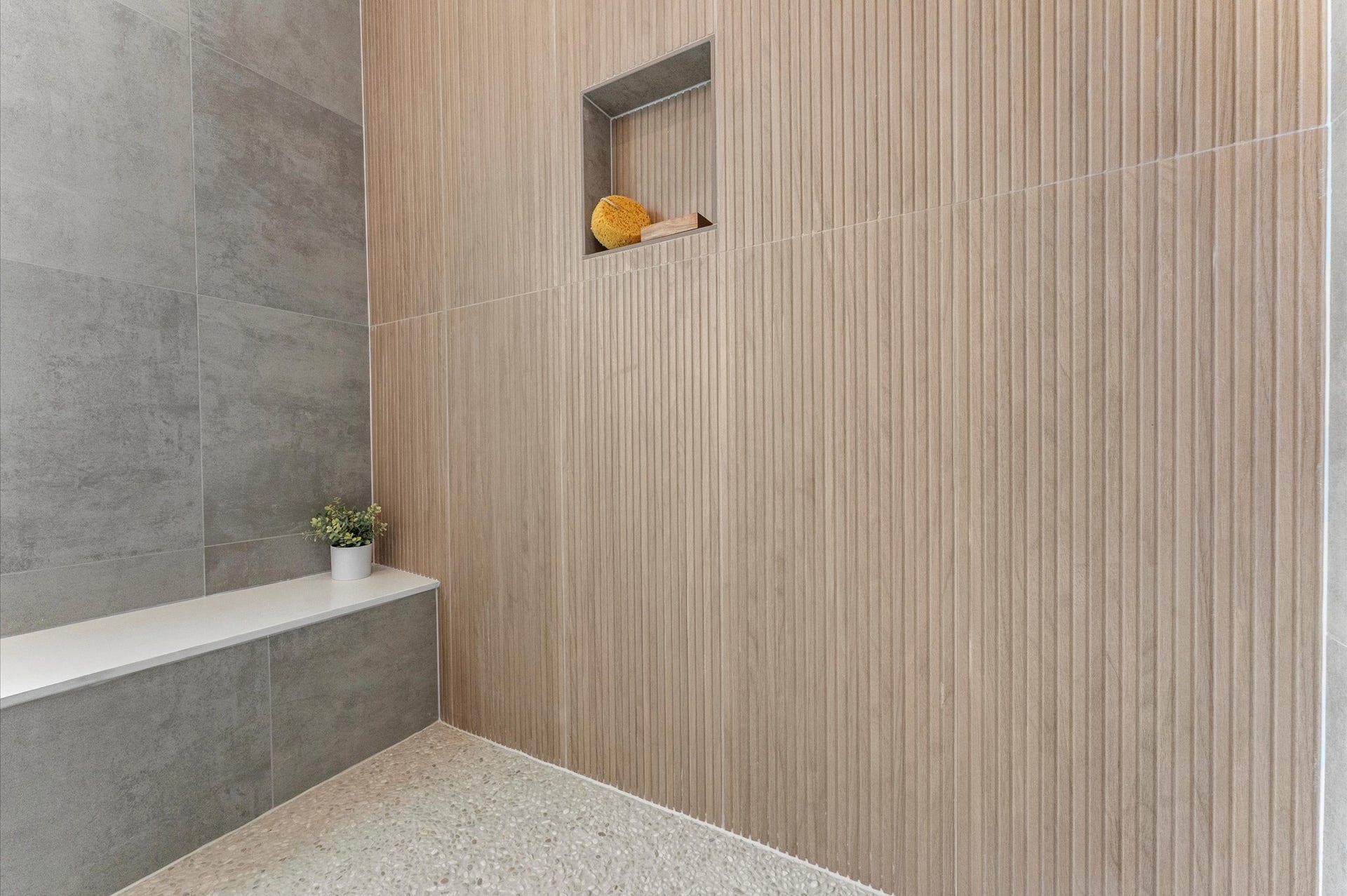 1009 Tuskegee Heights Lane, Houston, TX 77091 This luxurious primary bathroom blends modern elegance with spa-like comfort, featuring neutral tones, statement lighting, and refined tilework complete the space, creating a serene retreat thats both functional and visually stunning.