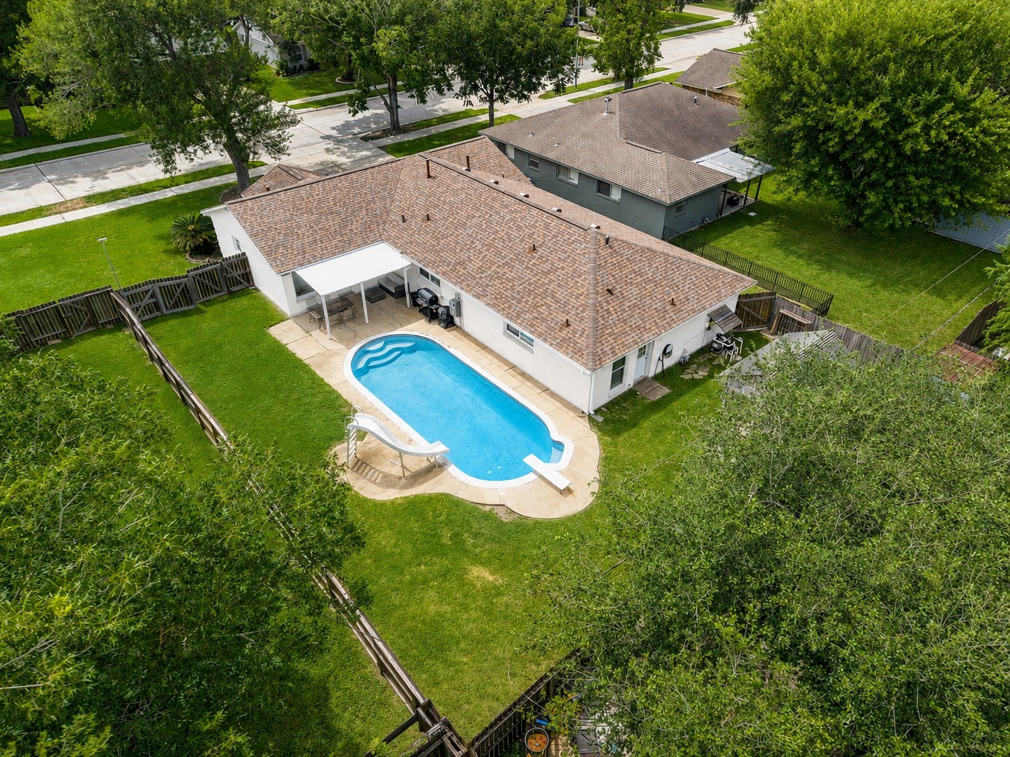 2309 Halbert Drive, Pearland, TX 77581 This aerial shot highlights the backyard oasis, showcasing a private and inviting outdoor space perfect for relaxation and entertaining.