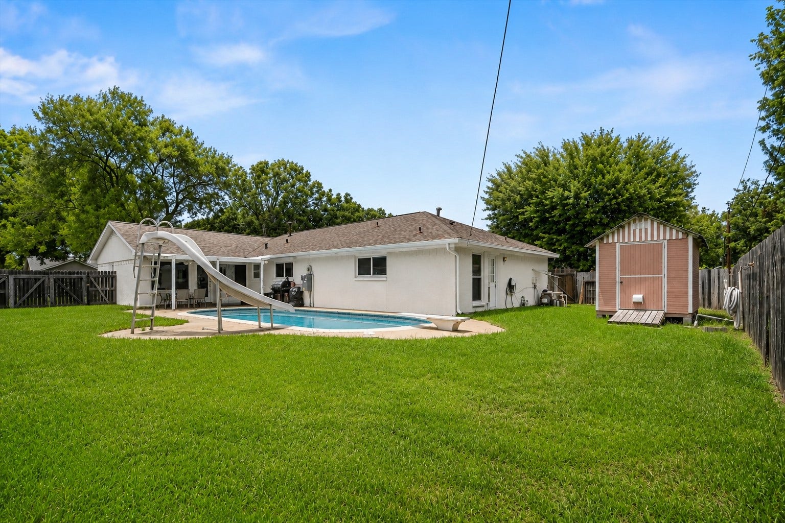 2309 Halbert Drive, Pearland, TX 77581 Enjoy another view of the spacious backyard, showcasing a lush green lawn.