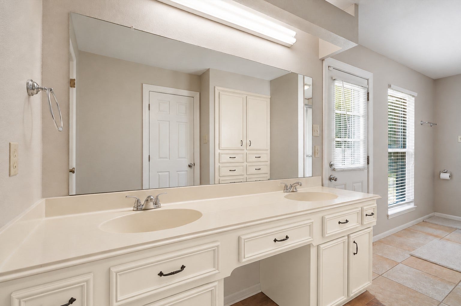 2309 Halbert Drive, Pearland, TX 77581 Indulge in the luxurious primary bathroom, showcasing a large double-sink vanity and tile flooring, creating a serene, spa-like retreat designed for relaxation and style.