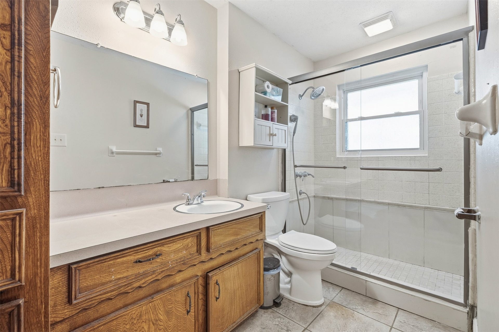2309 Halbert Drive, Pearland, TX 77581 This bathroom offers a classic double sink vanity, a large walk-in shower, and a modern toilet designed for both style and everyday comfort.