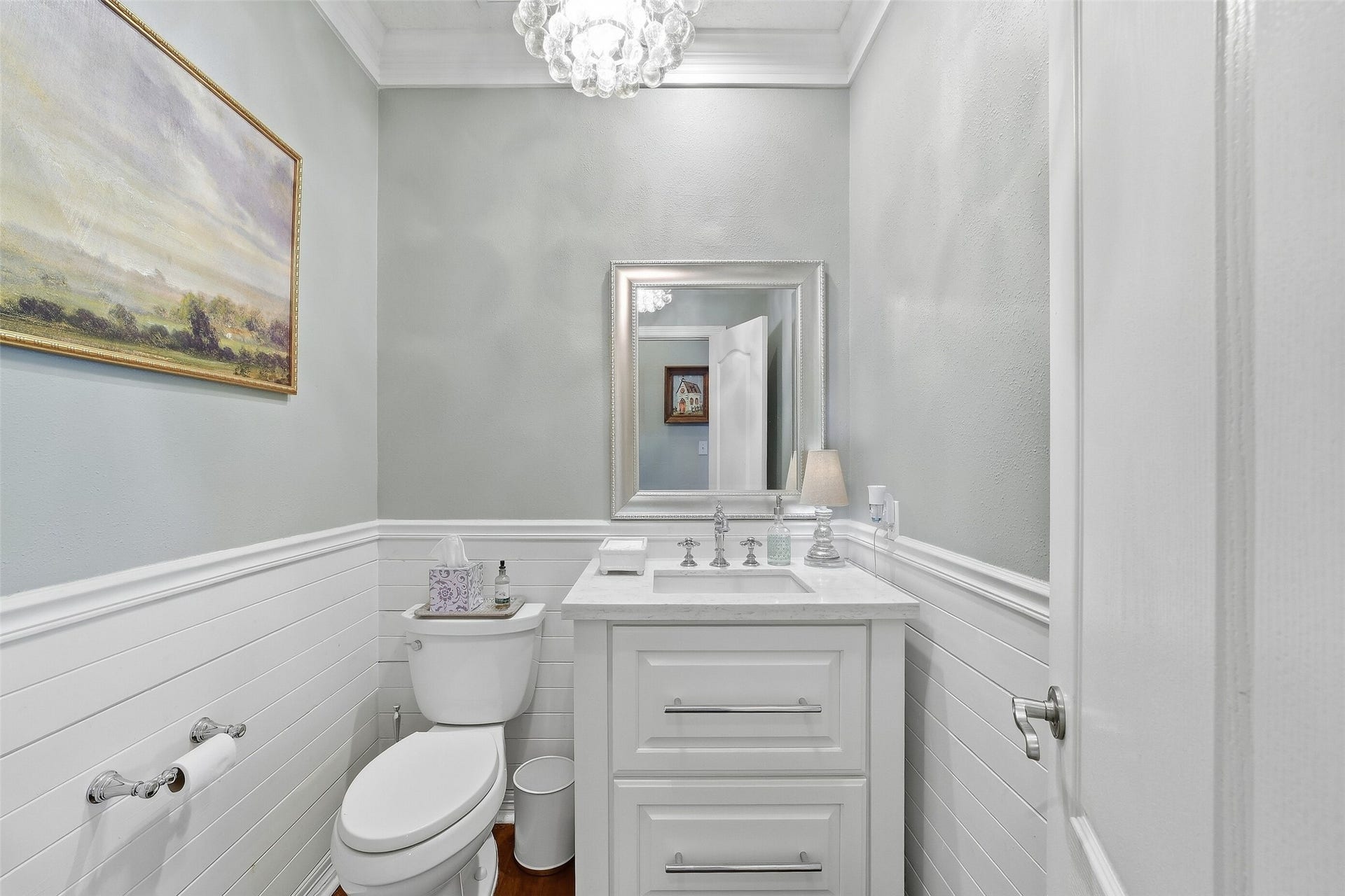 22514 Sierra Lake Court, Katy, TX 77494 Darling Guest Bathroom with Designer Lighting and Custom Shiplap tucked under the spiral staircase.