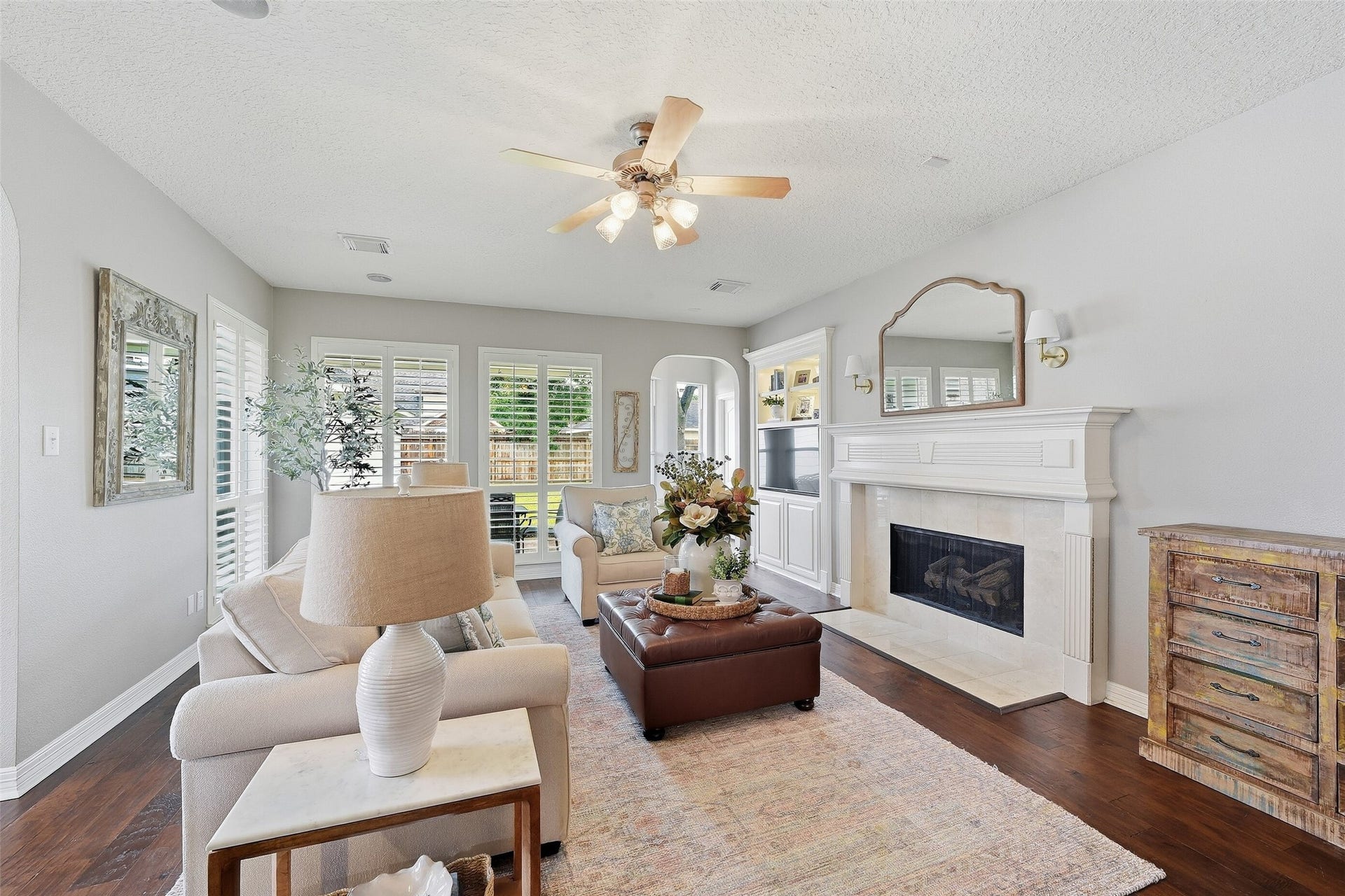 22514 Sierra Lake Court, Katy, TX 77494 Step into your cozy Living room equipped w/ gas log fireplace & Beautiful Shutters which frame the walls of Windows looking out to your spacious backyard.