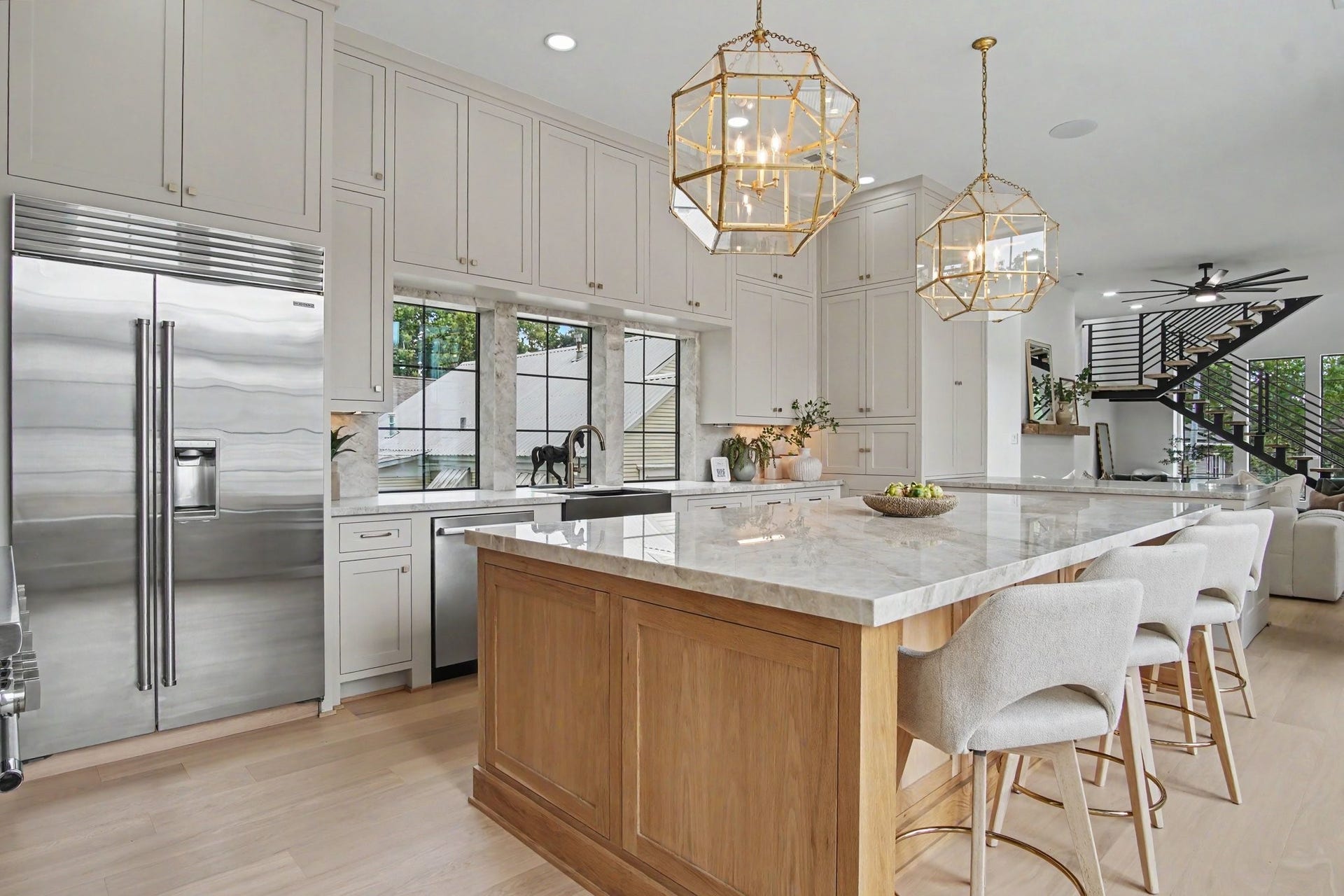 705 Walton Street, Houston, TX 77009 Elegant kitchen featuring chic gold pendant lighting and sleek Sub-Zero stainless steel appliances.
