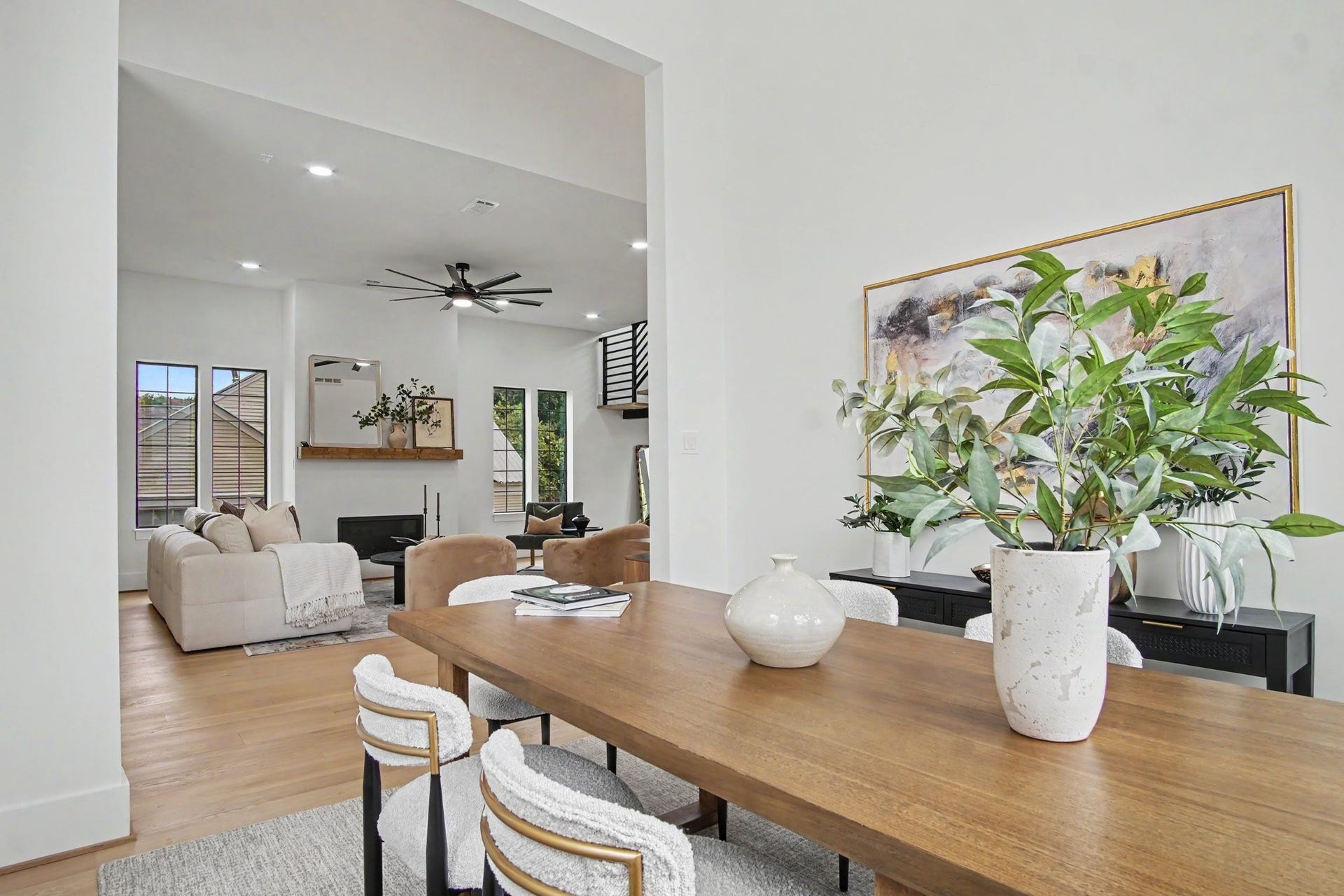 705 Walton Street, Houston, TX 77009 Spacious open-concept living and dining area featuring high ceilings, modern decor, and abundant natural light, perfect for entertaining and relaxation.