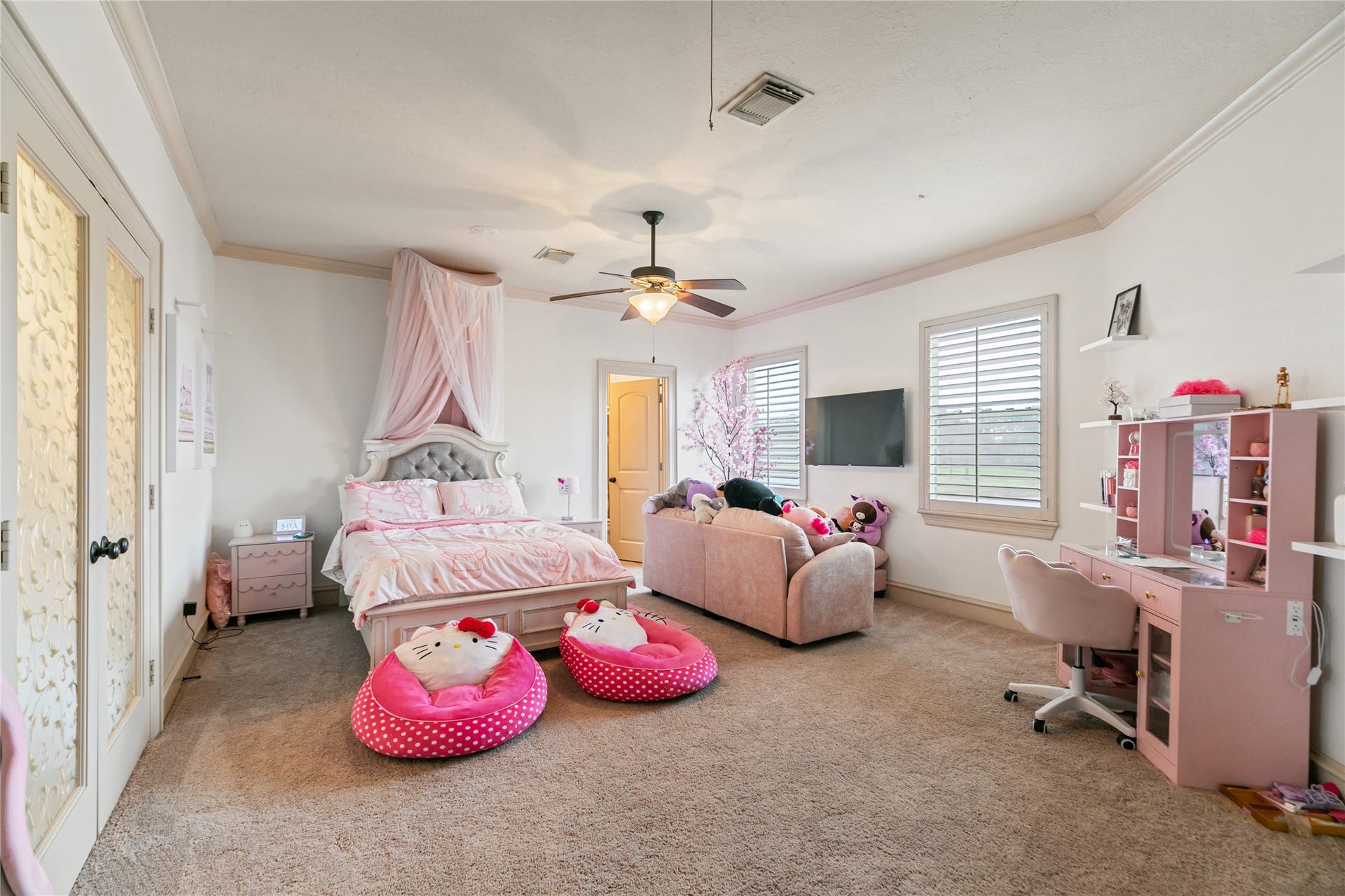 Secondary upstairs bedroom with large windows with plantation shutters.