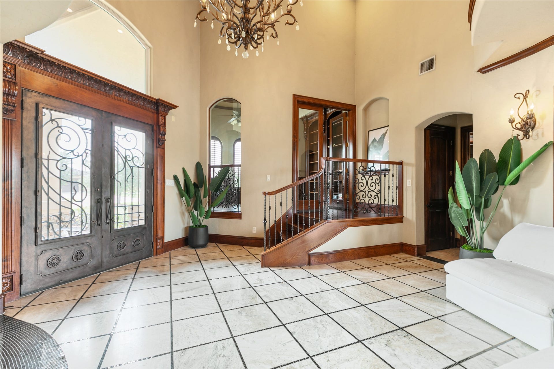 Stunning entrance with beautiful chandelier and front doors.  Welcome home.
