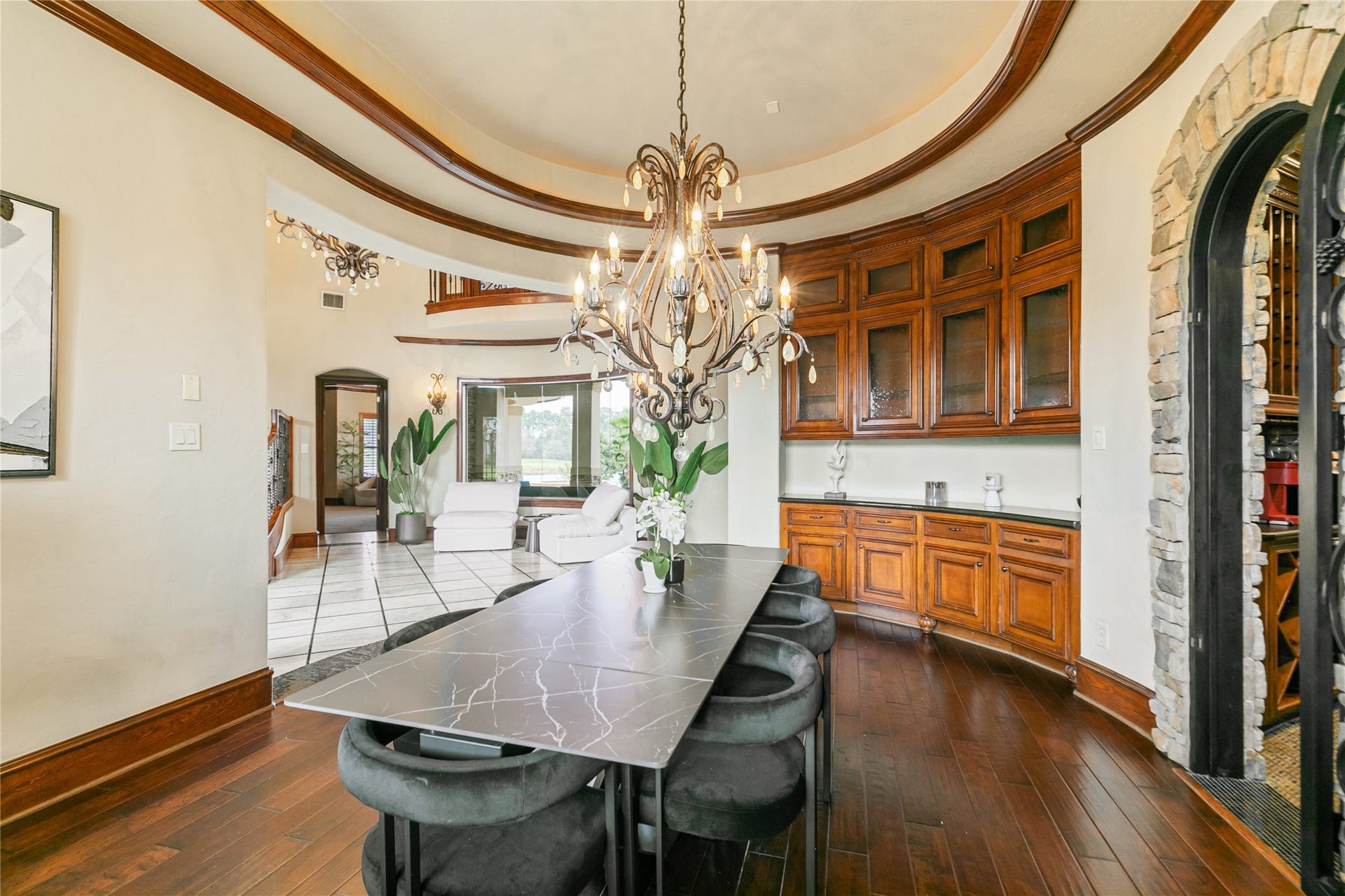 Another view of beautiful dining room with custom cabinets and rich wood flooring.