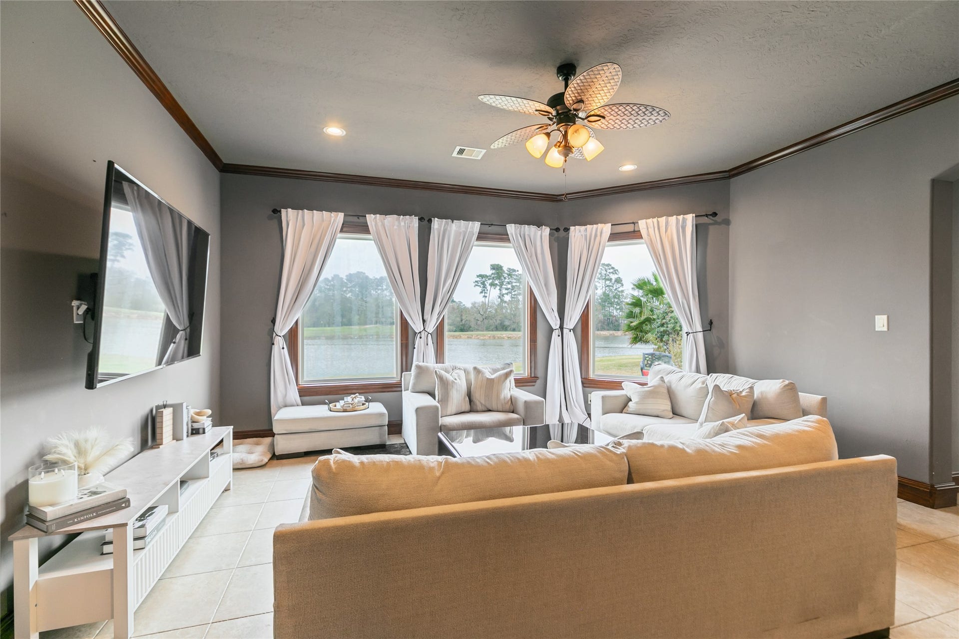 Light fills the large den in the attached apartment through windows overlooking the back yard.