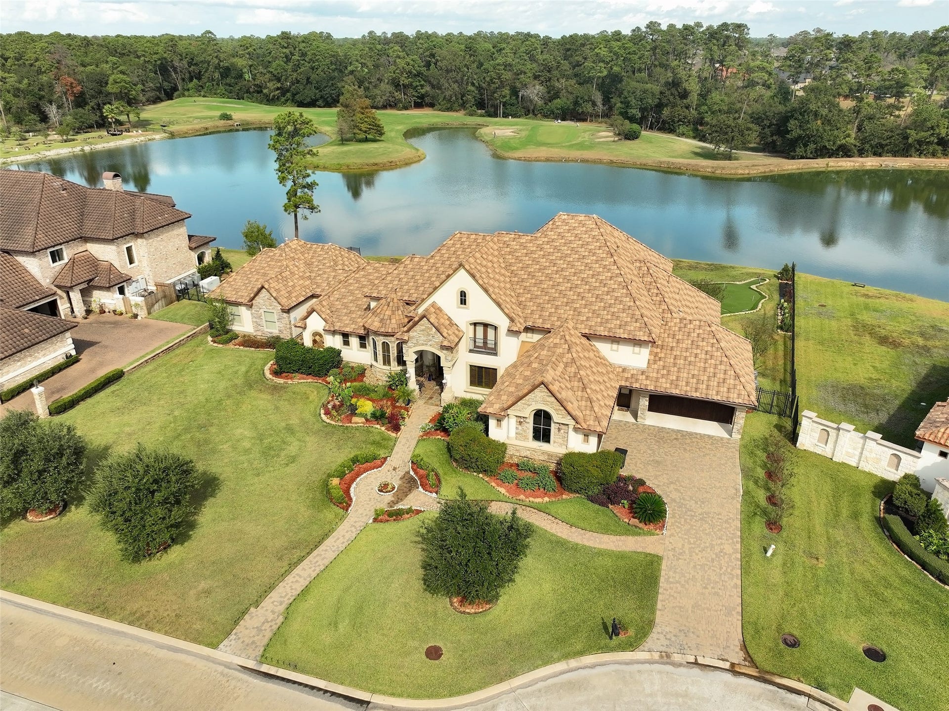 Aerial view highlighting beautiful home, lake and fairway.