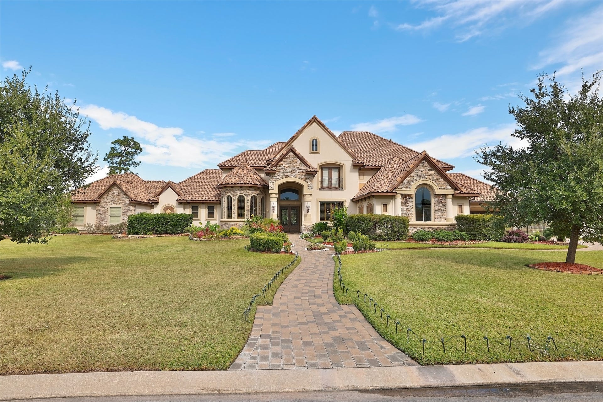 Gorgeous home with lovely landscaping creating stunning curb appeal.