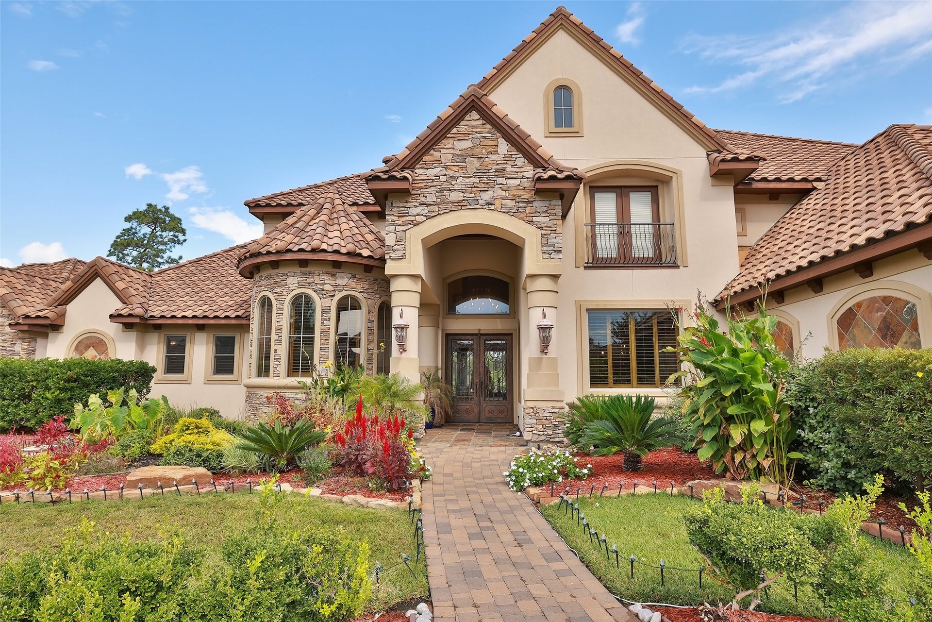 Beautiful elevation, front door and landscaping welcome you to this gorgeous home.