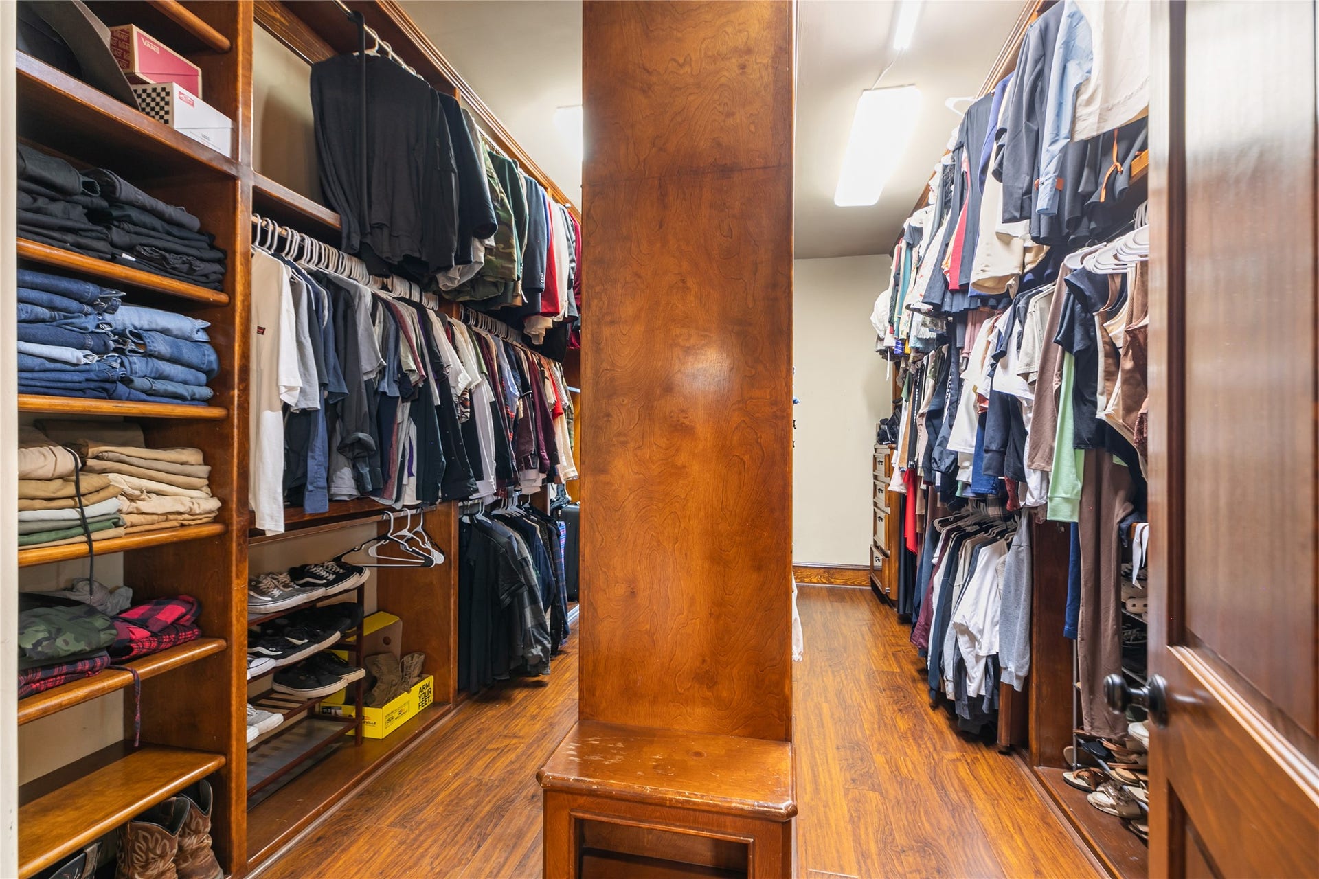 Large primary closet with built-in shelves provides plenty of space for all your needs.