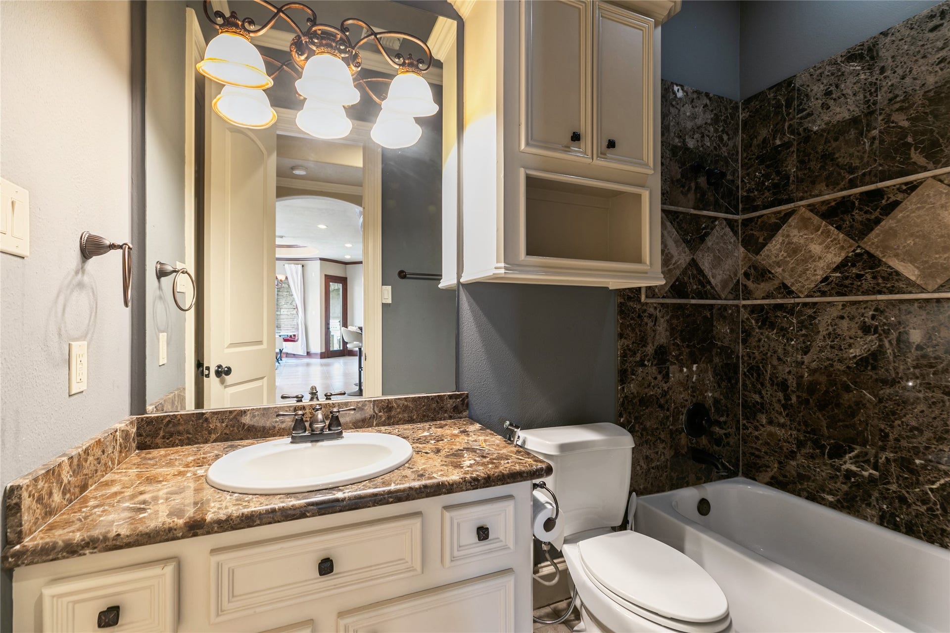 Attractive downstairs secondary bathroom with granite counter and lovely tile shower.