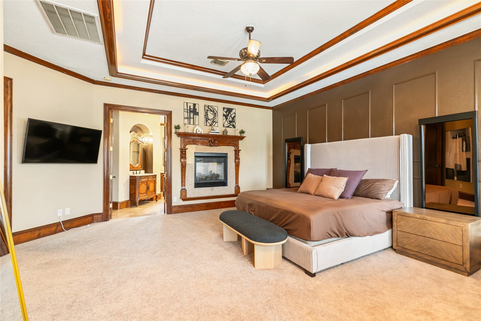 This primary suite is elevated by the shared fireplace with the primary bath creating a cozy and relaxing atmosphere.