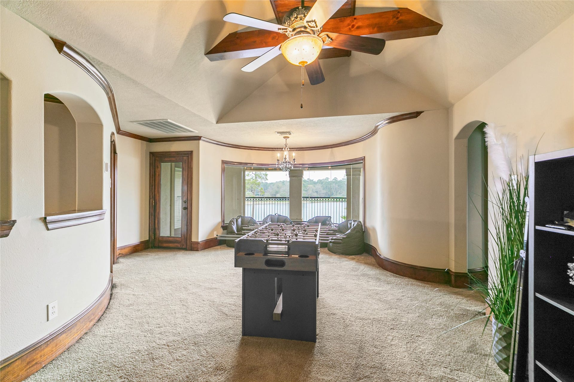 Fabulous game room with beautiful wood accents and large window and balcony overlooking the back yard, lake and golf course.