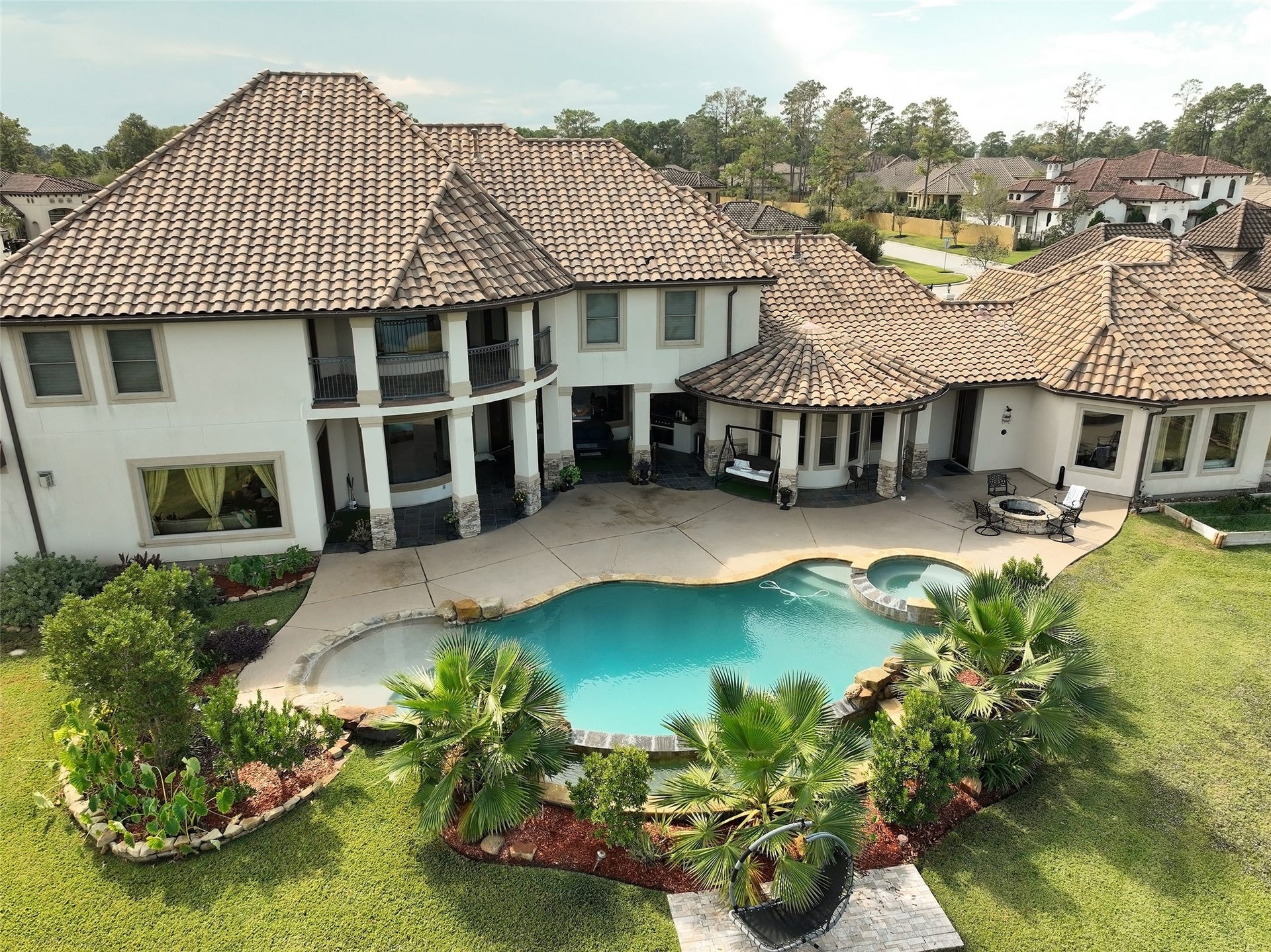 Another aerial view of the home highlighting the backyard oasis.