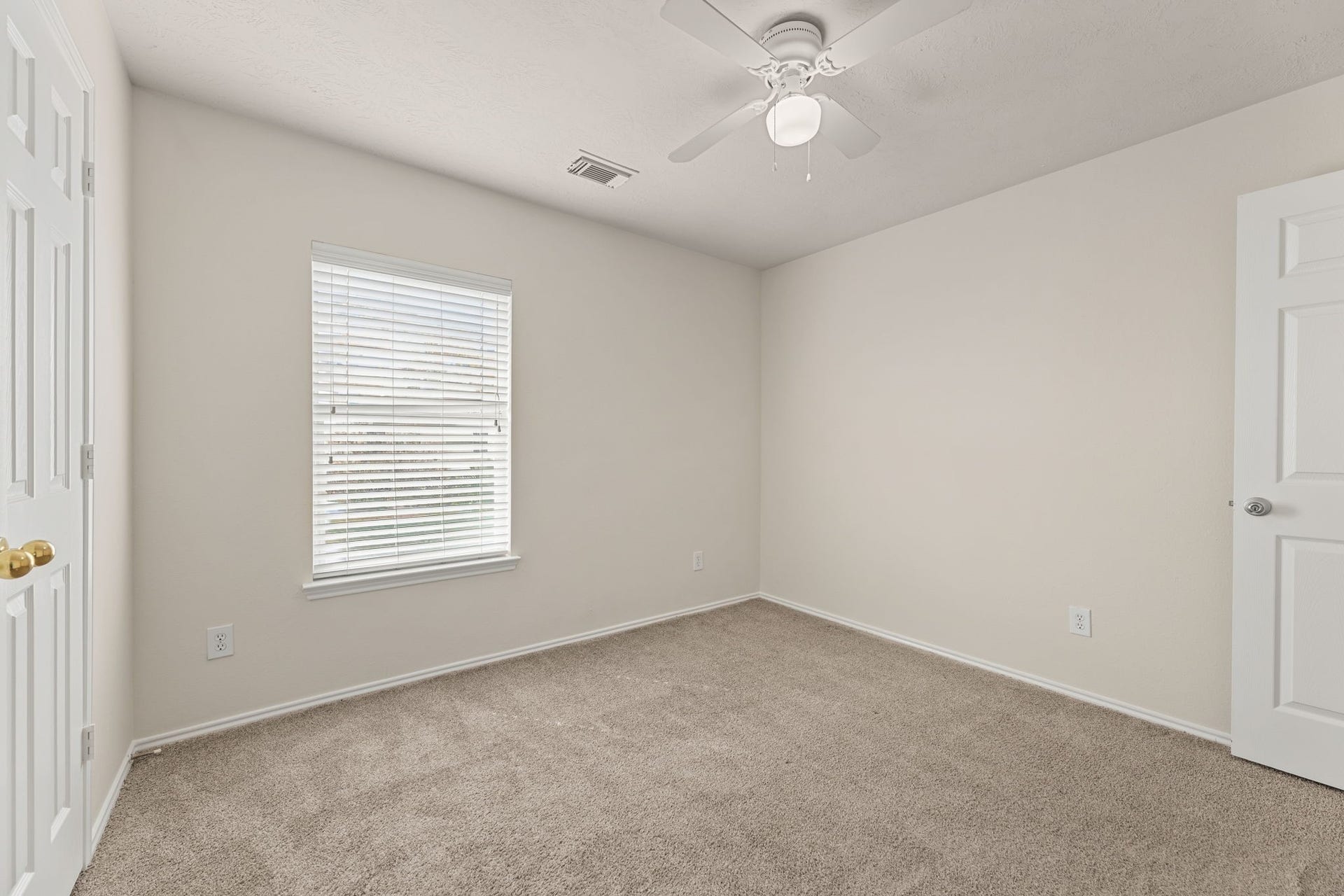 Another view of the naturally lit secondary bedroom.