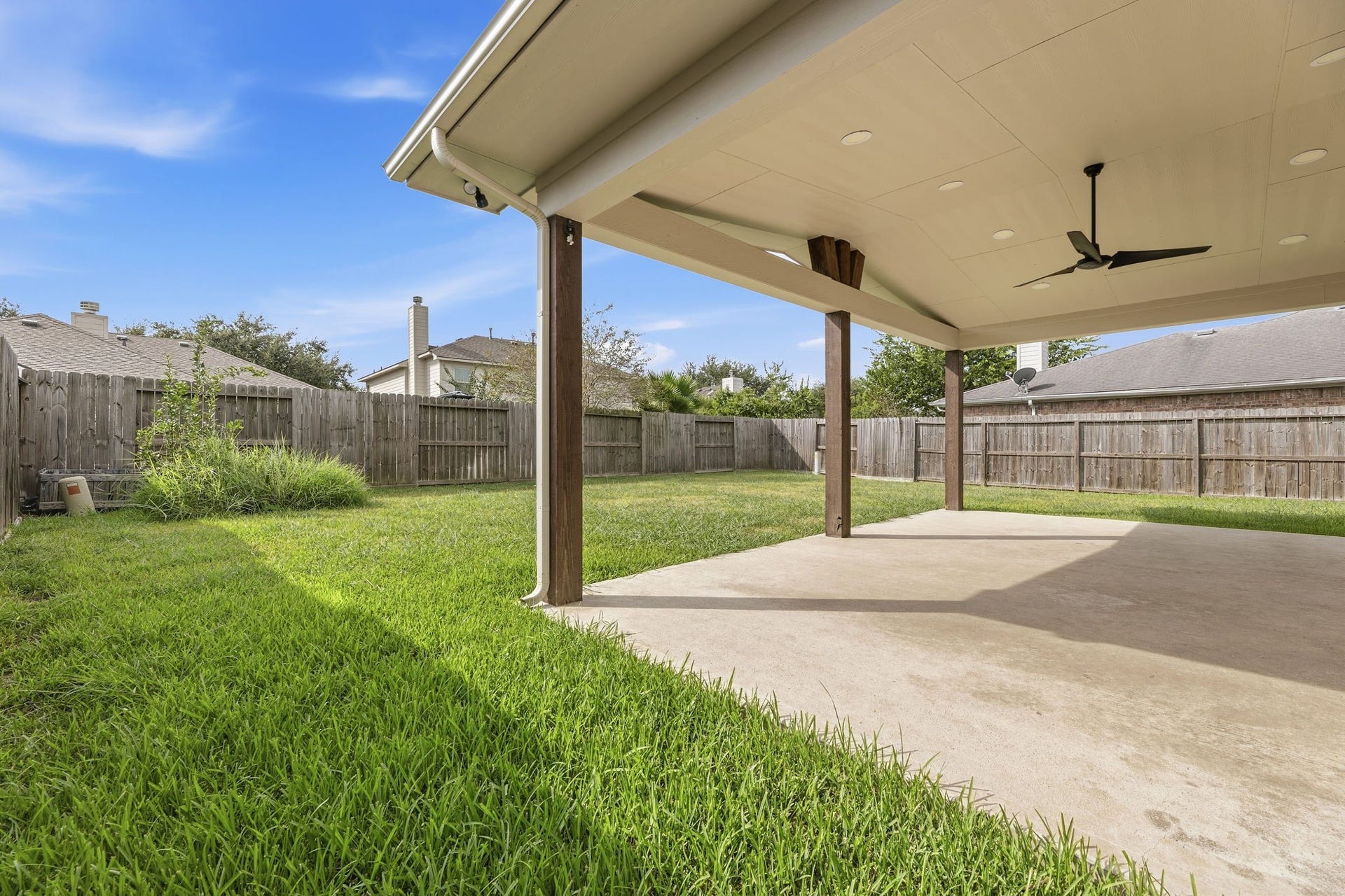 The back of the home shows the solar panels, the covered patio, and a privately fenced yard. Schedule your tour today!
