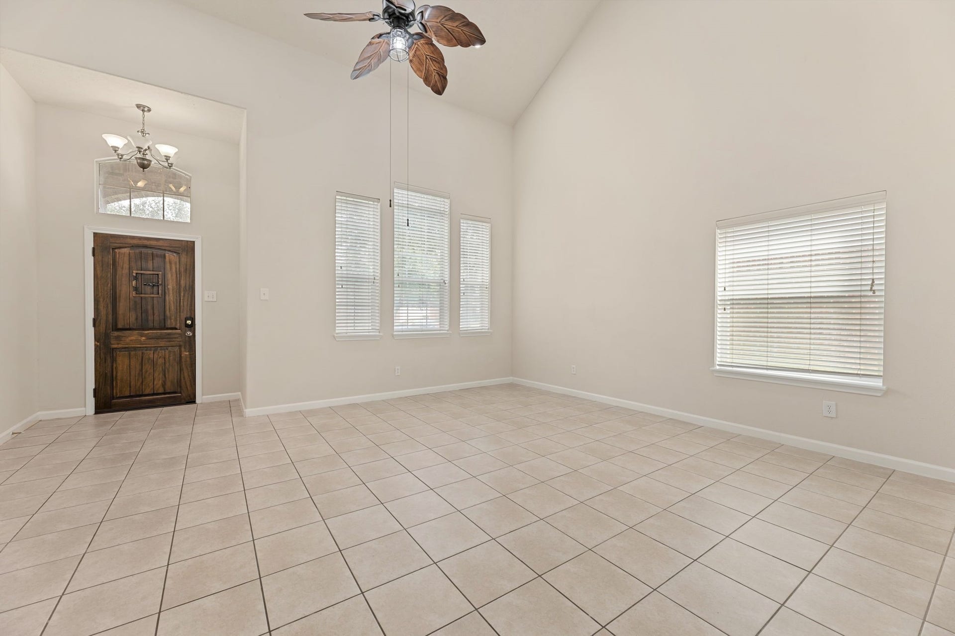 Vaulted ceilings and a trio of front windows make this a versatile spot for dining, a home office, or a second living area.