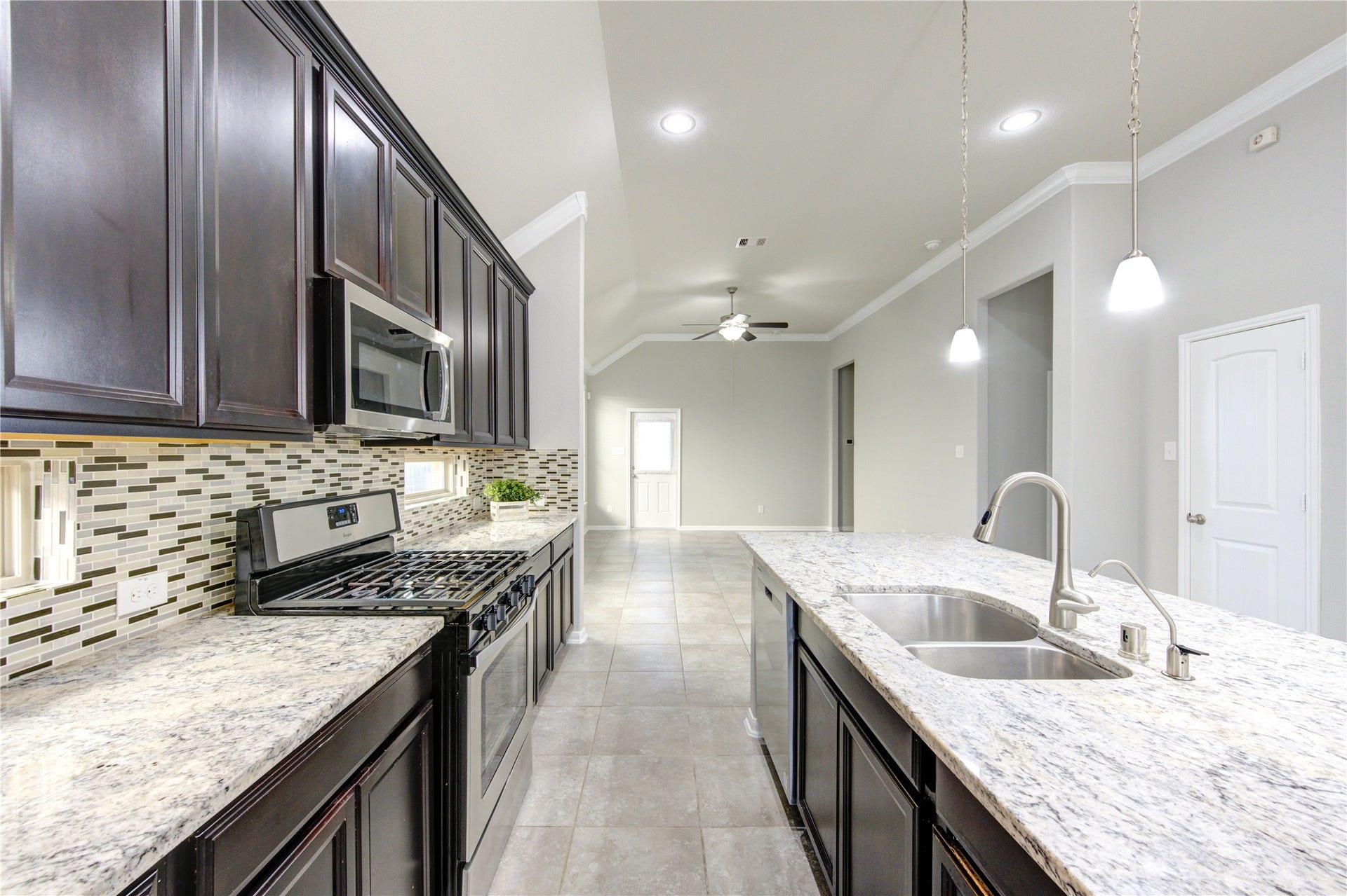 5314 Silver Ledge Drive, Katy, TX 77493 This photo shows a laundry area with washer and dryer hookups, a wall-mounted shelf for storage, and utility connections. The space is clean and ready for appliances.