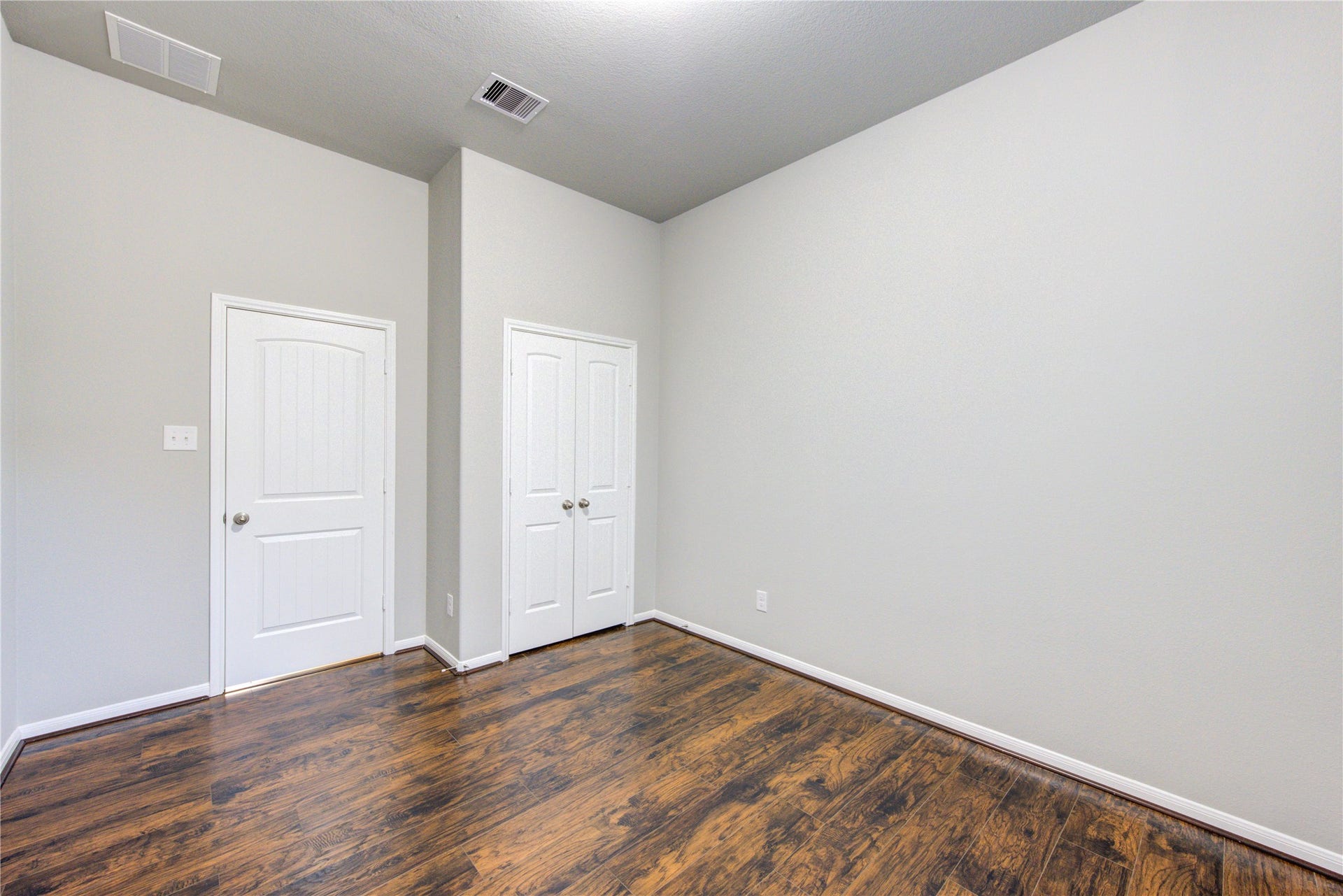 5314 Silver Ledge Drive, Katy, TX 77493 This photo shows a modern second bathroom with a glass-enclosed shower, a sleek vanity with a white countertop, and a large mirror. The room is well-lit with stylish lighting.