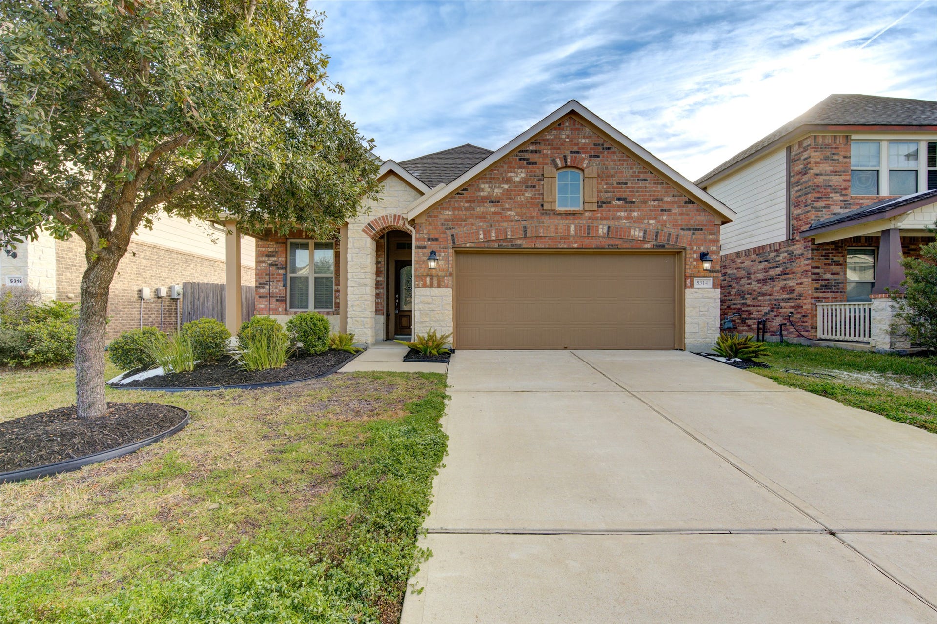 5314 Silver Ledge Drive, Katy, TX 77493 This charming brick home features a welcoming front porch, well-maintained landscaping, and a two-car garage. The arched entryway adds character, and the driveway offers ample parking.