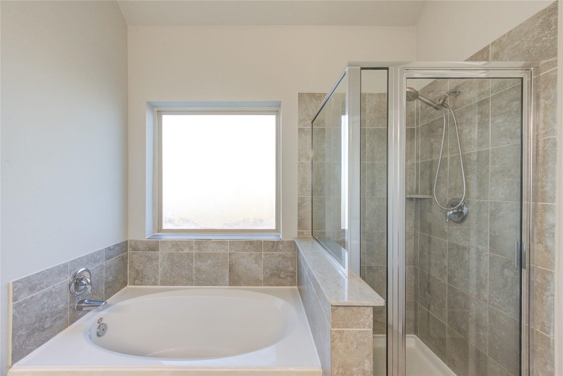 5314 Silver Ledge Drive, Katy, TX 77493 Spacious walk-in closet with multiple wooden hanging rods and light-colored walls, providing ample storage space.