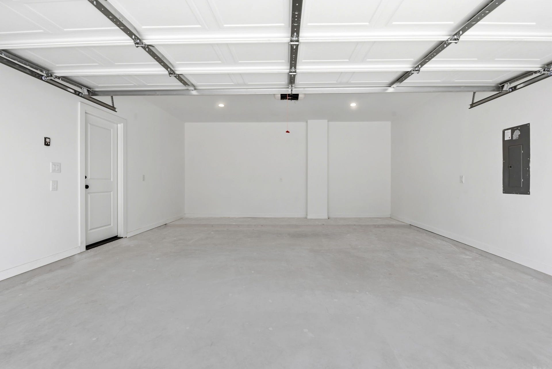 6117 Haight Street, Houston, TX 77028 Spacious, clean garage with a white interior, overhead lighting. Plenty of space for additional storage.