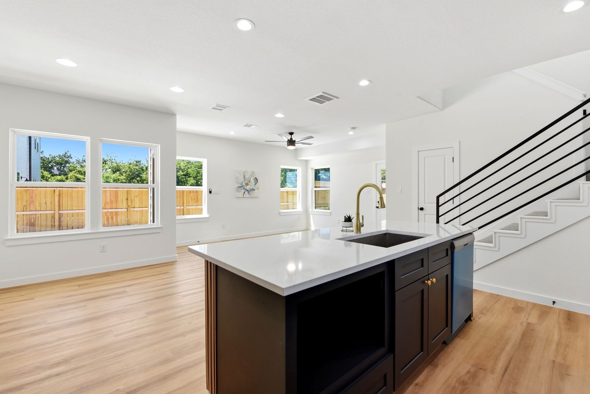 6117 Haight Street, Houston, TX 77028 Bright, open-concept living space with large windows, modern kitchen island with microwave.