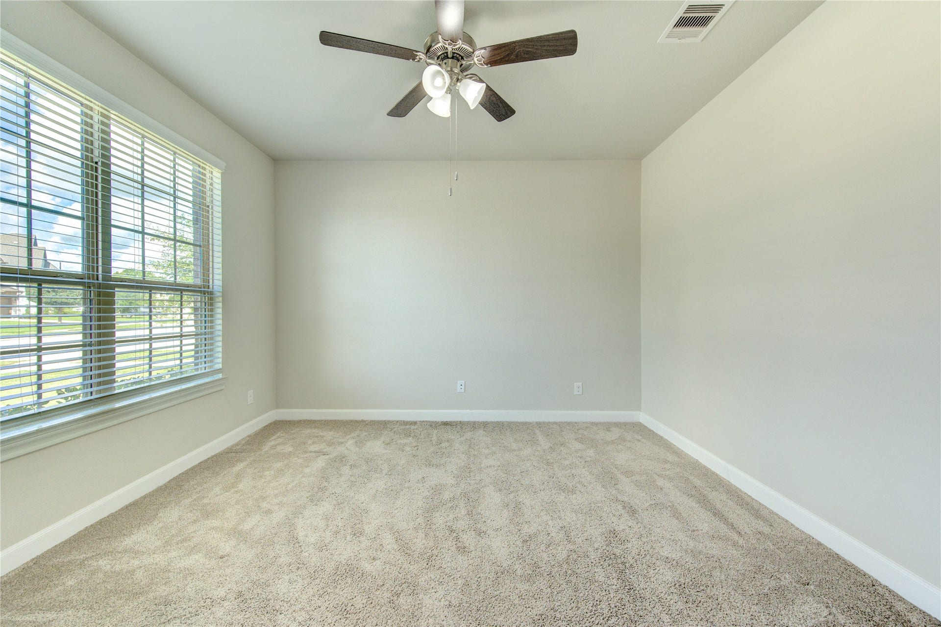 2334 Green Kale Drive, Richmond, TX 77406 The bright and spacious front office features plush carpet (installed with thicker carpet padding to make the work from home experience better) and large windows that fill the space with natural light.