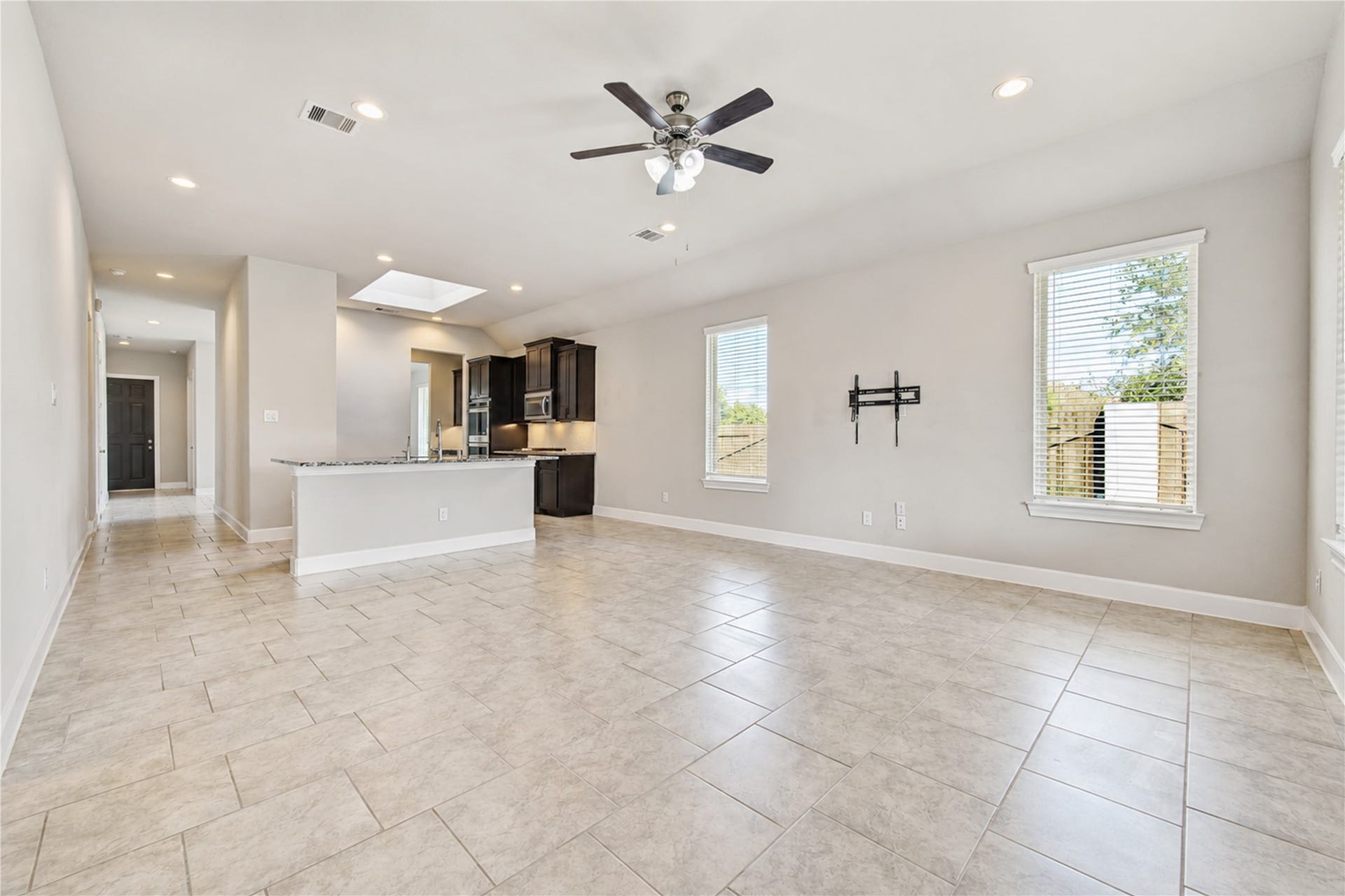2334 Green Kale Drive, Richmond, TX 77406 The open-concept living area features abundant natural light from large windows, flowing from the modern kitchen.