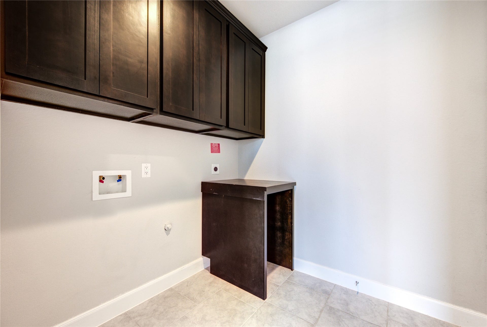 2334 Green Kale Drive, Richmond, TX 77406 The laundry room, adjacent to the dining room and off the garage entry, offers additional custom cabinetry for storage, along with a built in folding table that sits perfectly next to your dryer.